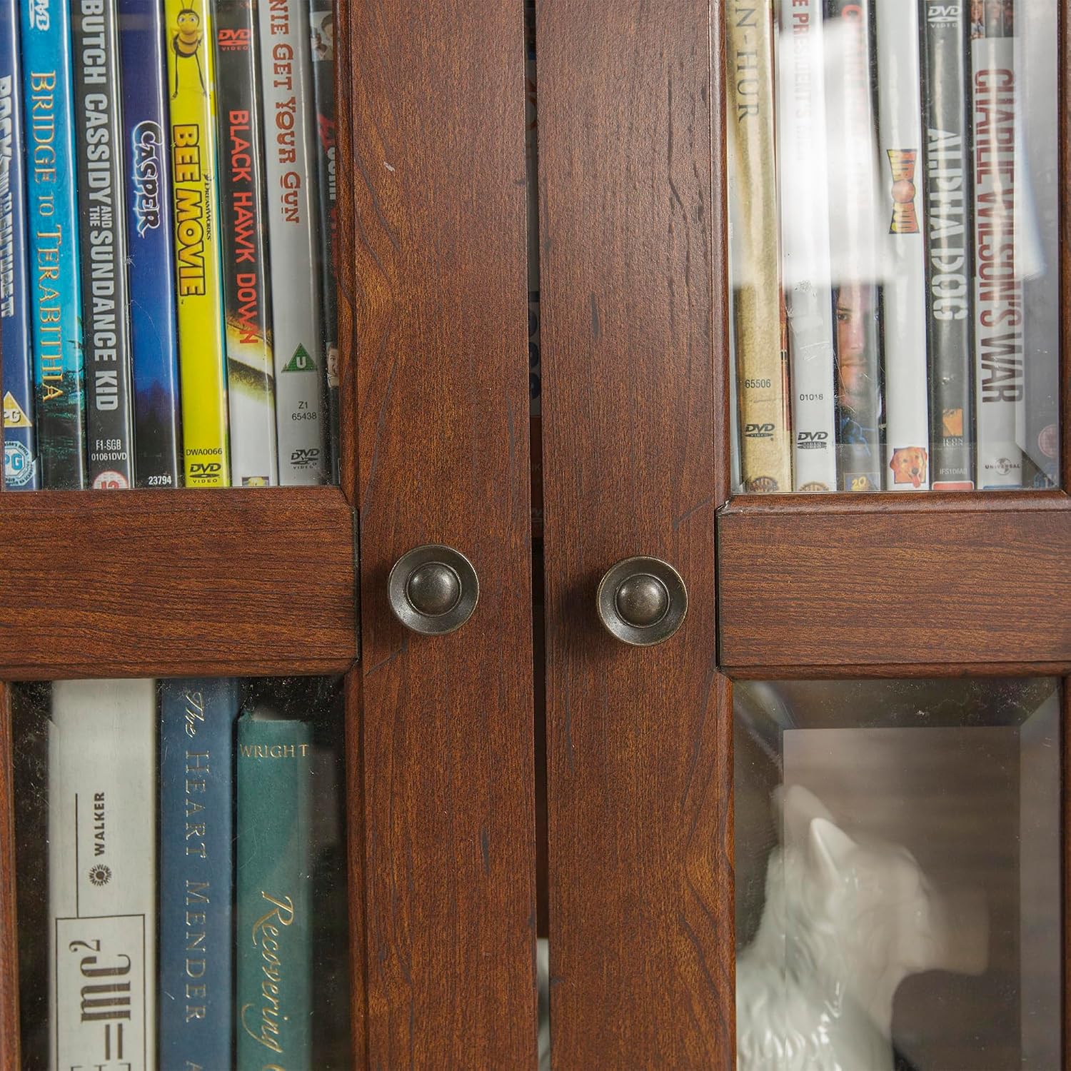 Detailed view of the Walker Edison 4-Tier Storage Cabinet shelves filled with books and media.