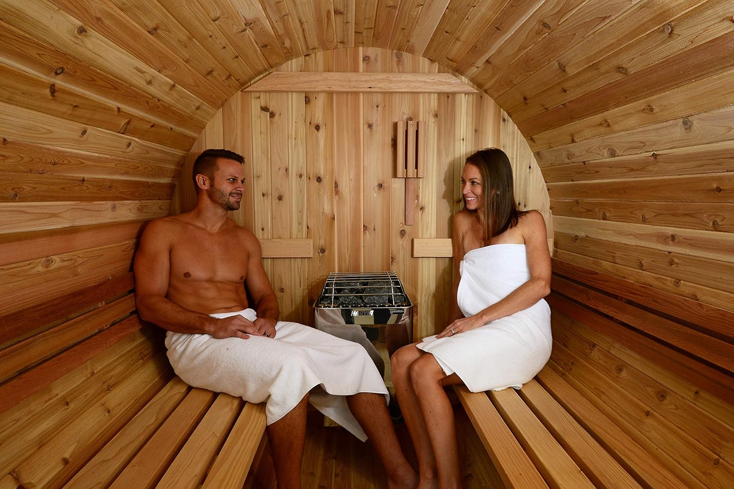 Couple enjoying a sauna session together on the benches
