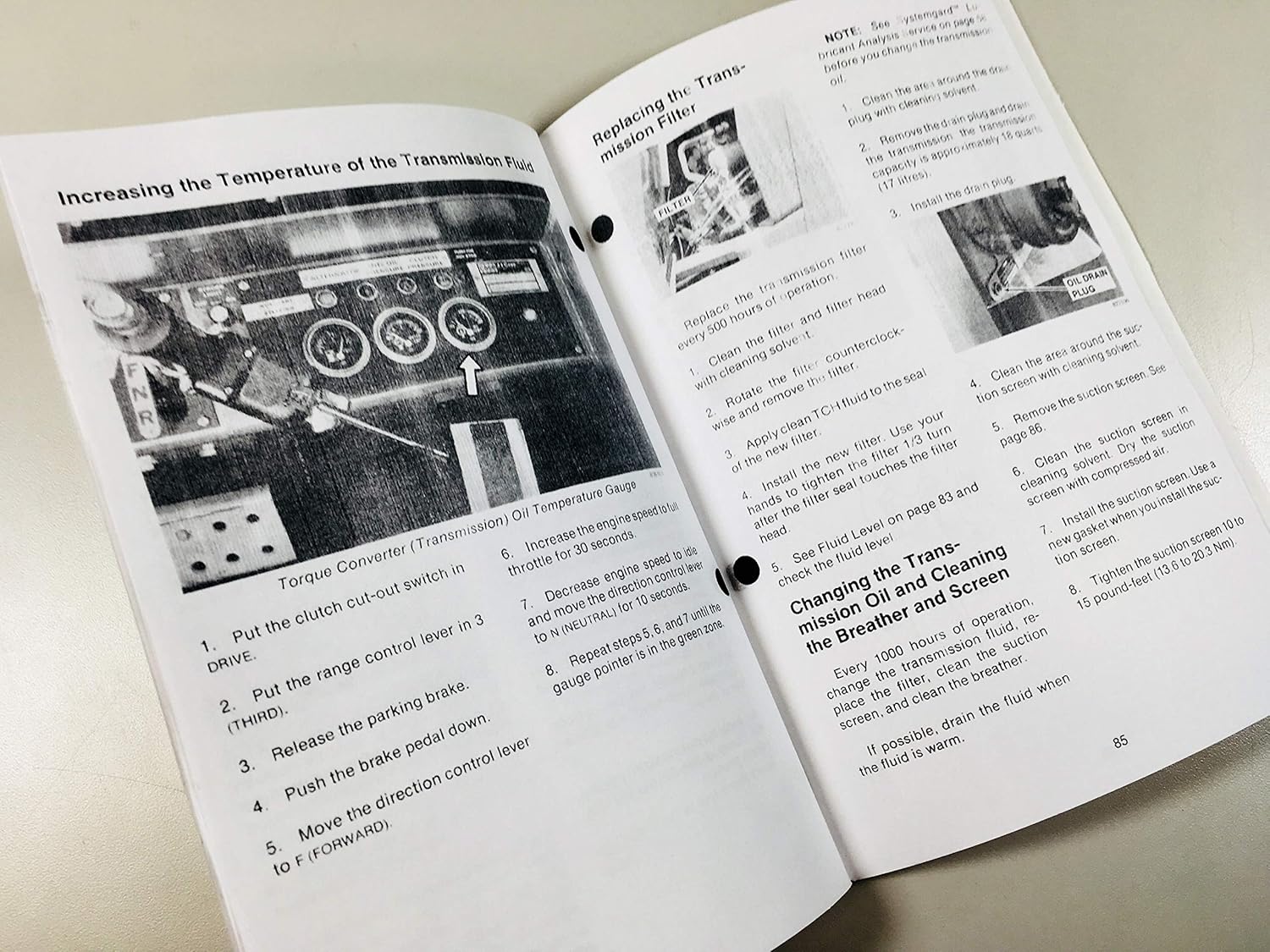Pages from the manual showing transmission filter replacement and fluid temperature increase