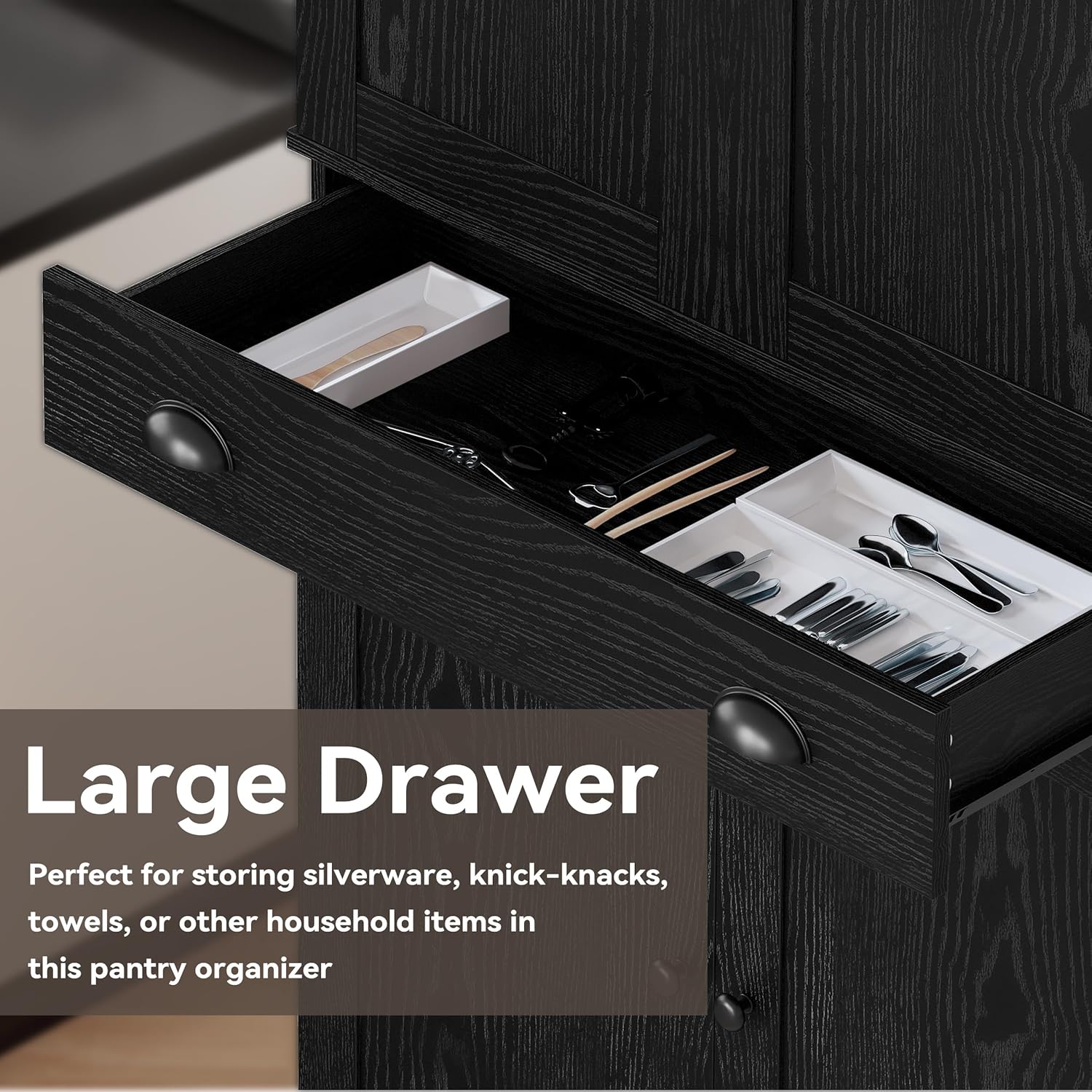 Close-up image of the large drawer, containing cutlery and small organizers
