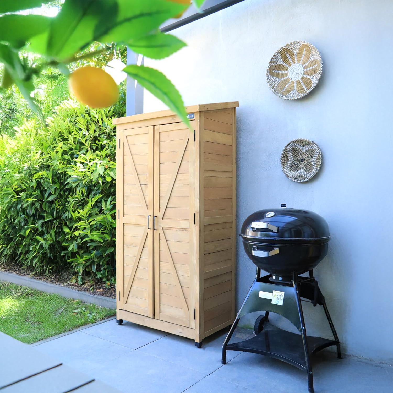 AXI Hugo Garden Cabinet placed in an outdoor garden setting next to a grill