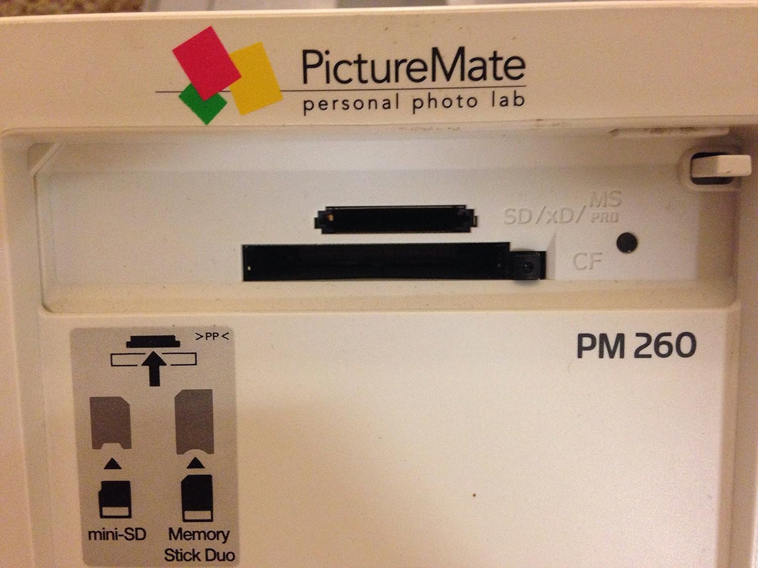 Epson PictureMate Dash PM260 printer with top cover open, showing control panel and LCD screen