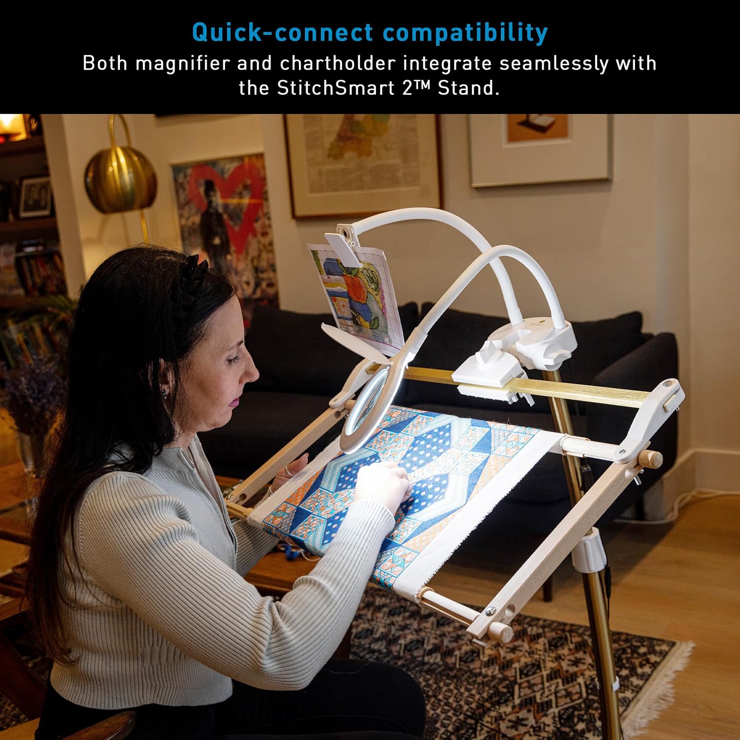 User demonstrating quick-connect compatibility of magnifier and chartholder with the StitchSmart 2 stand
