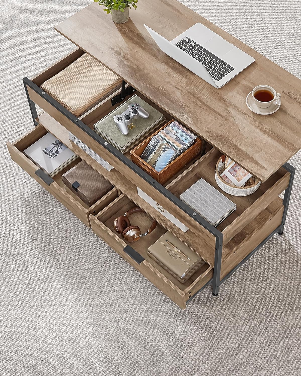 Үстүңкү view of the VASAGLE LCT252K02 coffee table showing its internal storage compartments and drawers filled with various items.