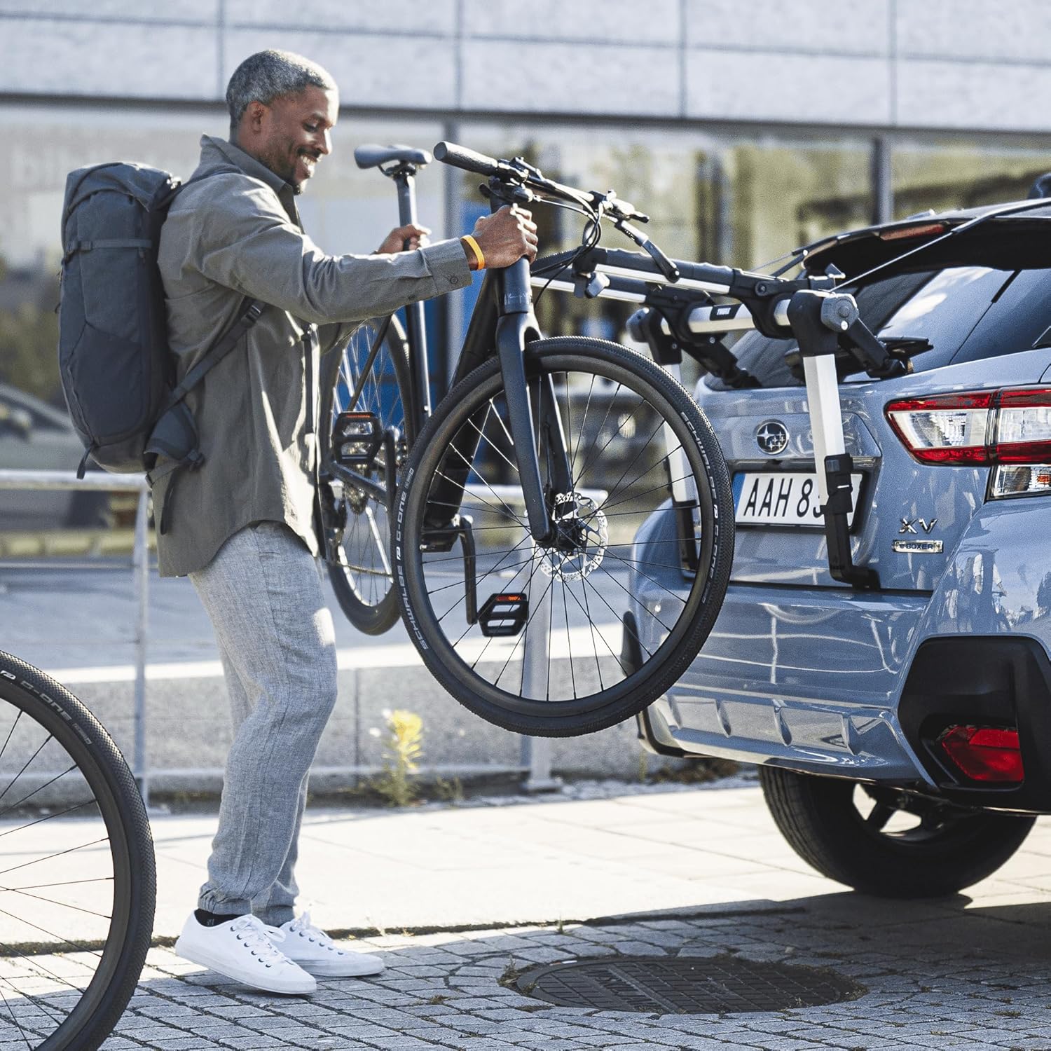 Person loading a bicycle onto the Thule Outway rack