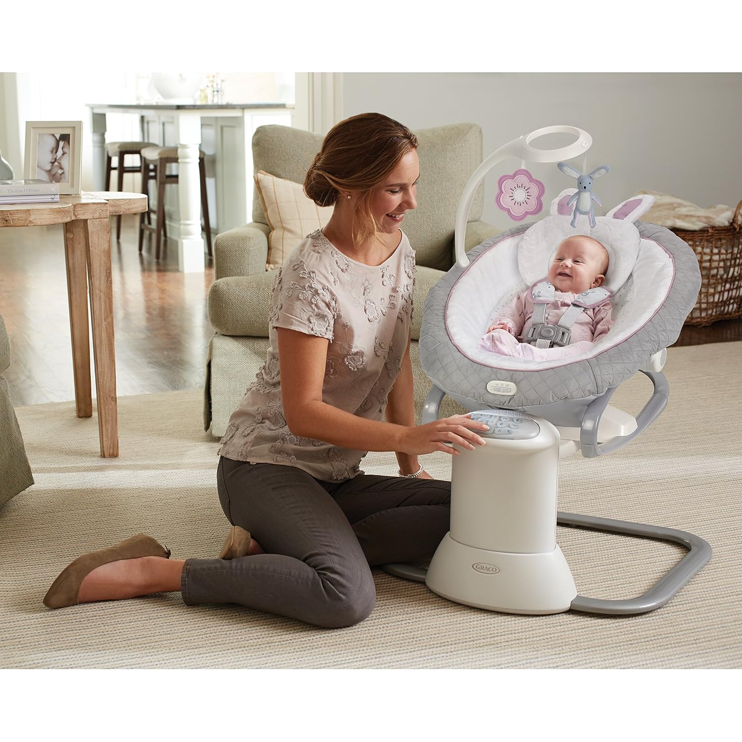Parent adjusting settings on the Graco EveryWay Soother Baby Swing.