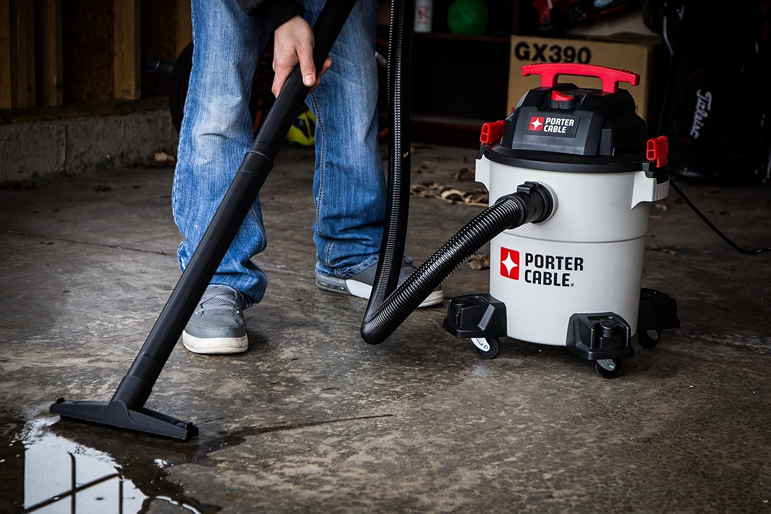 Person using the wet/dry vacuum to clean up a liquid spill