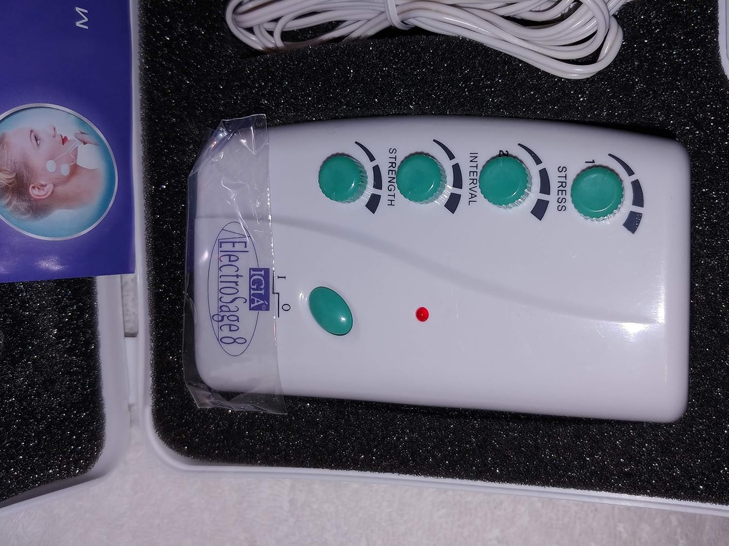 Close-up of the Igia ElectroSage 8 control unit showing the power button and four adjustment dials for Strength, Interval, and Stress.