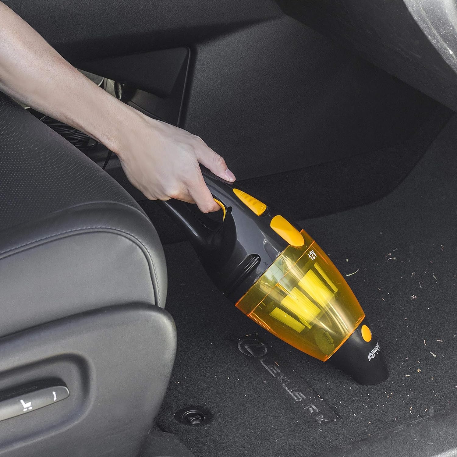 User vacuuming a car floor with the Wagan EL7207