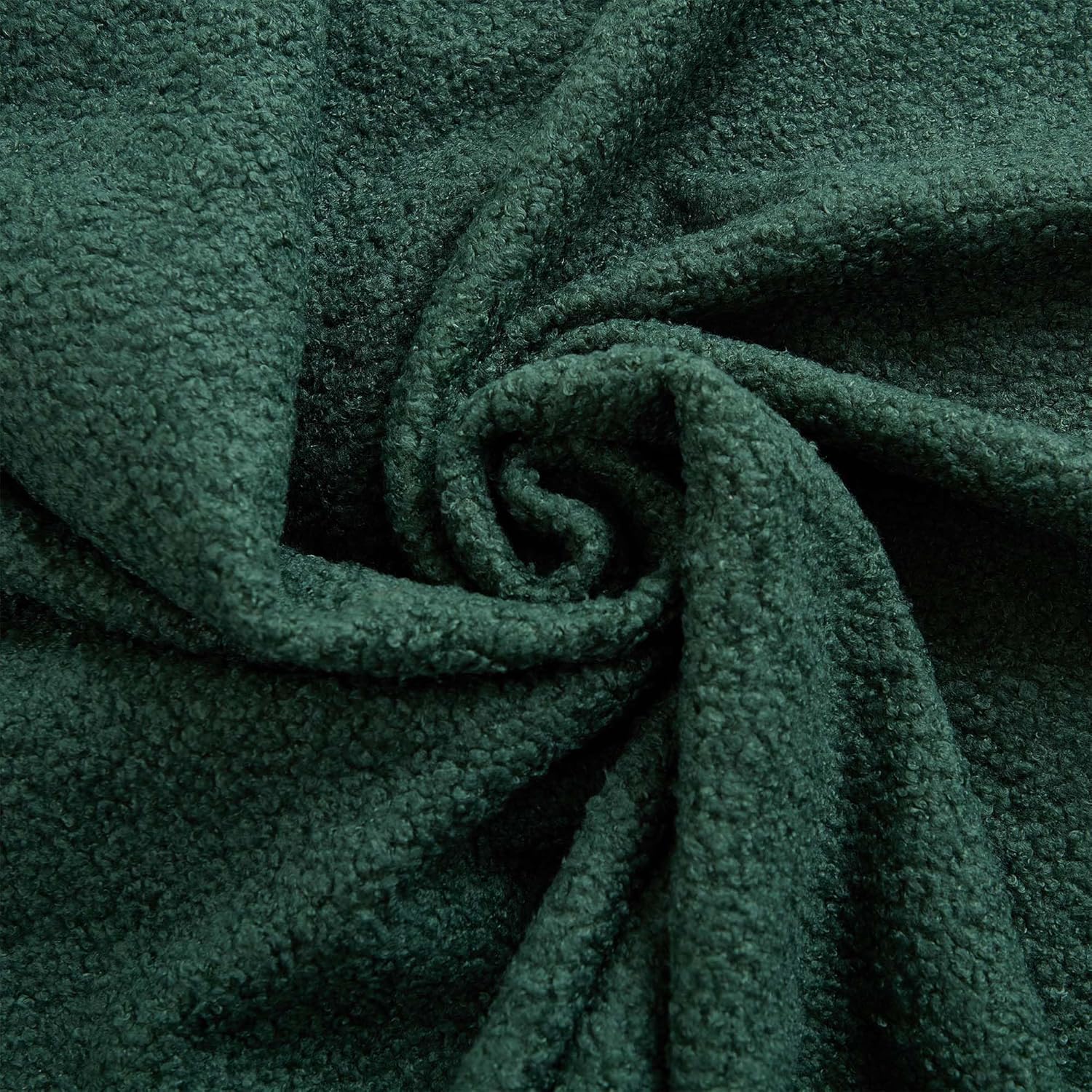 Close-up of the green teddy fabric texture, showing its soft and plush appearance.