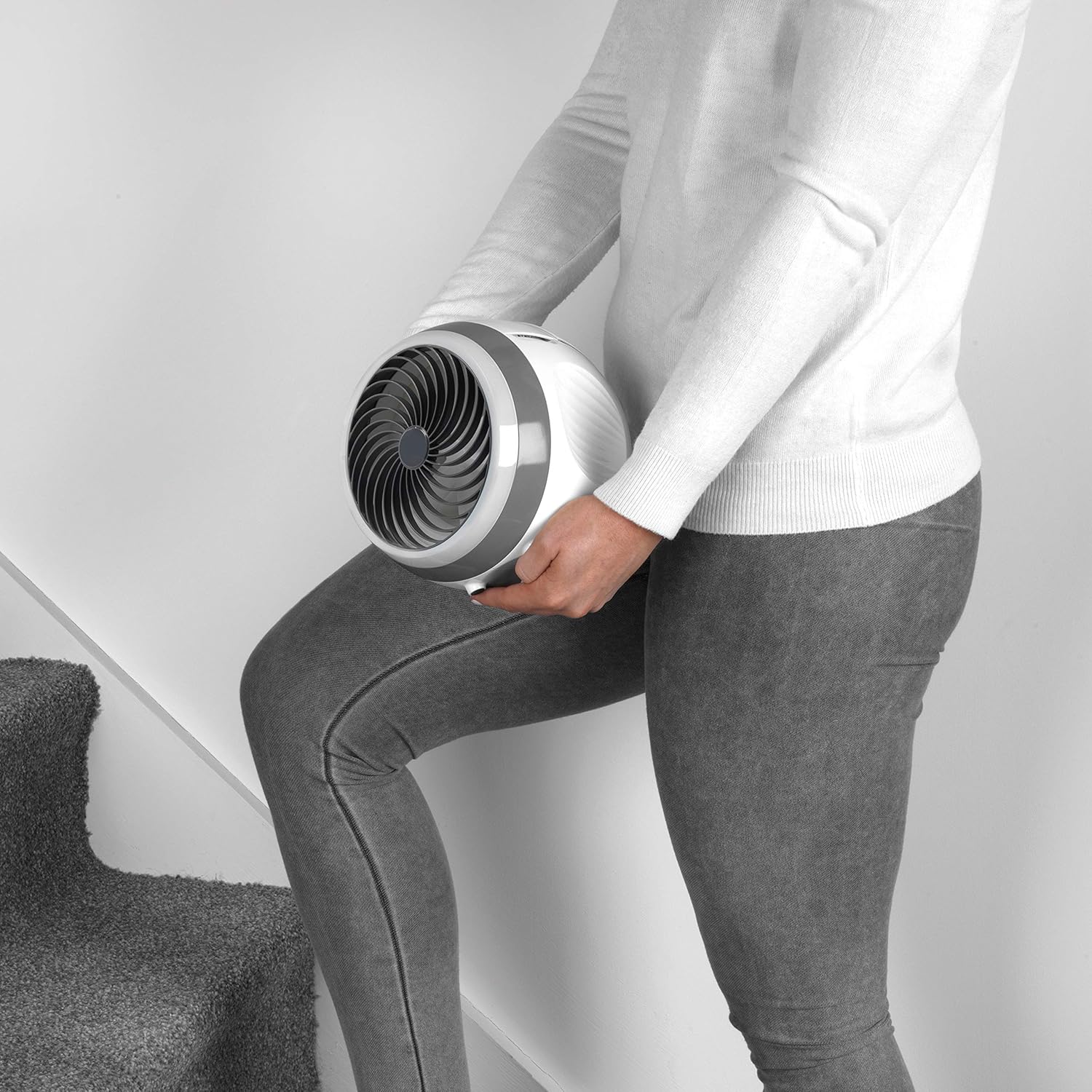 Person carrying the portable Beldray Arctic Dome Air Cooler up stairs.