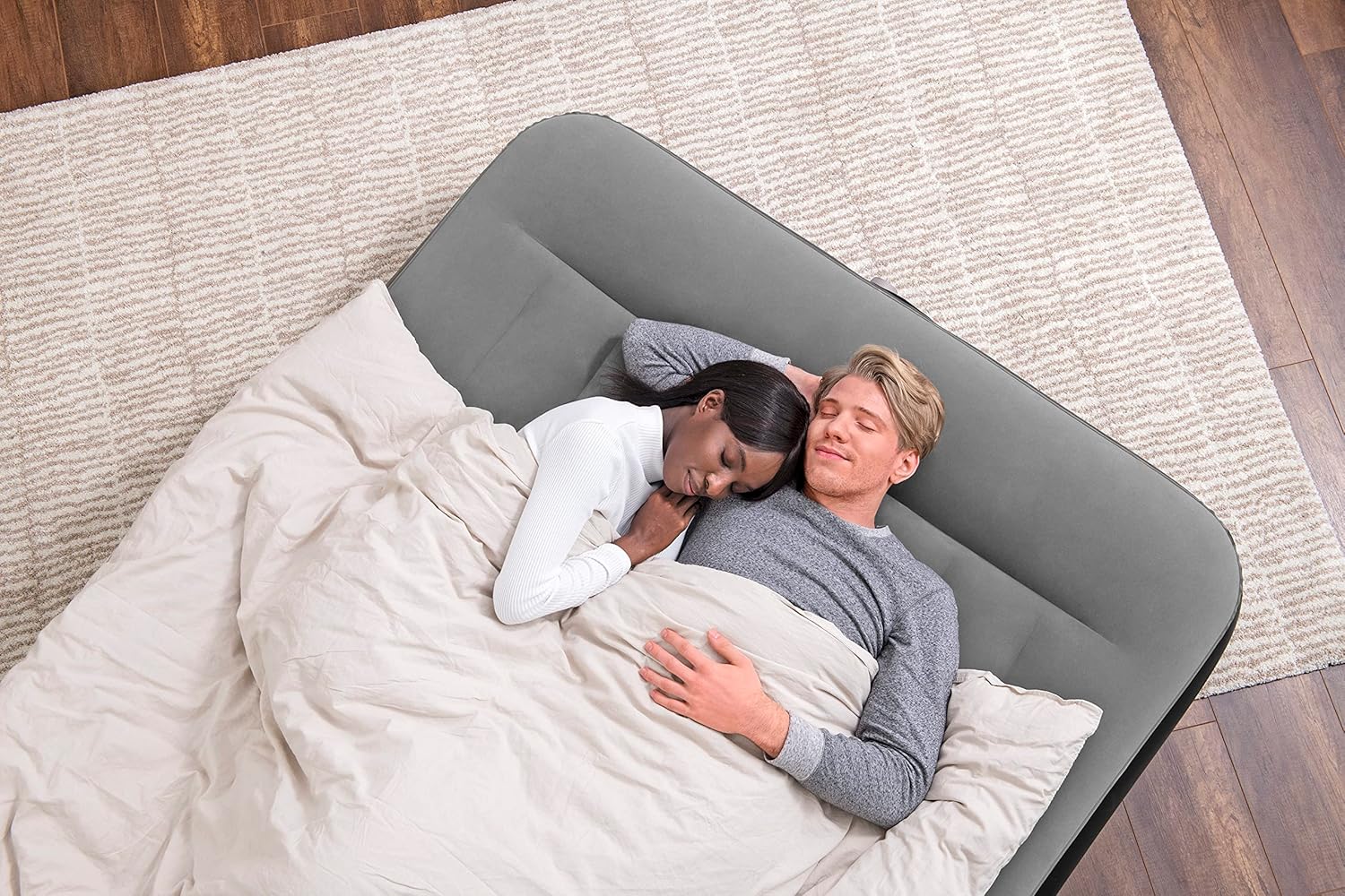 A couple sleeping on the Bestway Tritech air mattress, viewed from above.