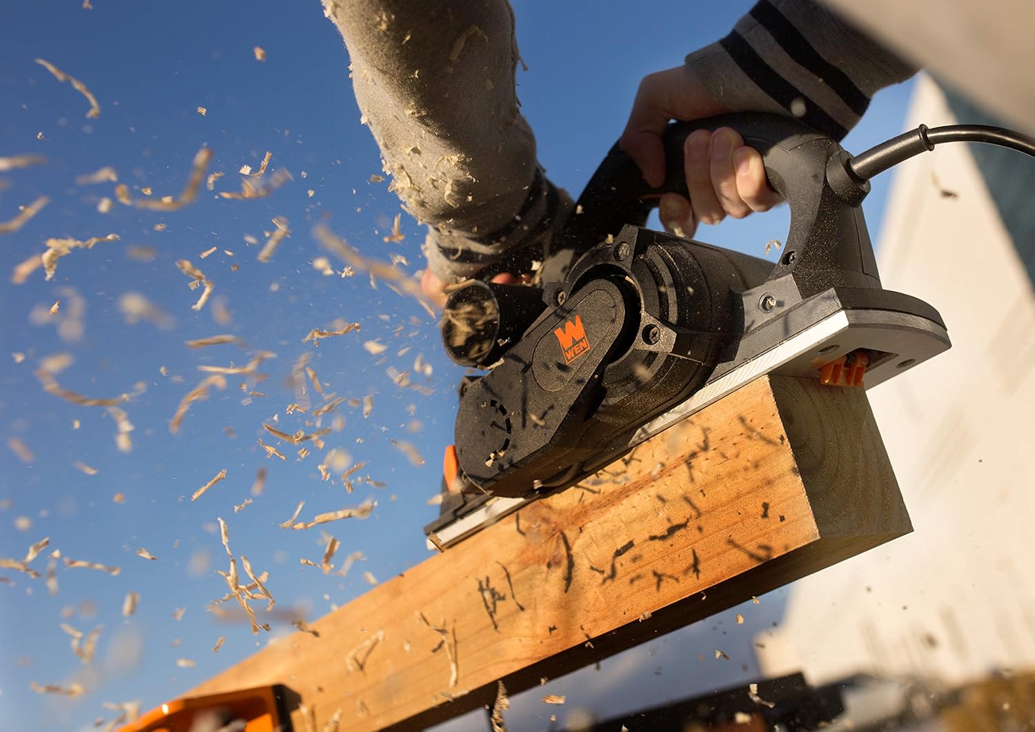 WEN 6534 Hand Planer resting on a wooden board outdoors
