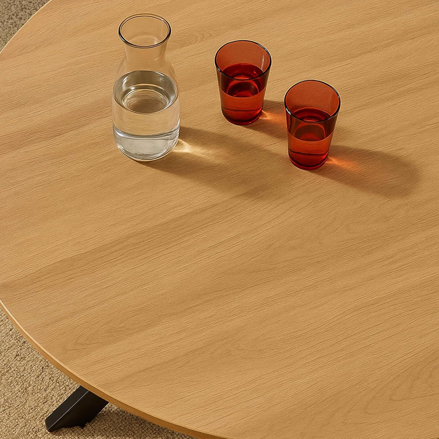 Close-up of the Oviala dining table's wooden top with glasses