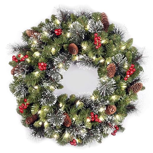 National Tree Company 24 in Pre-Lit Crestwood Spruce Artificial Christmas Wreath, Christmas Decoration with Glitter, Pinecones, Red Berries, 50 Clear LED Lights, 160 Tips, Timer, Green