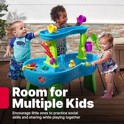 Children developing motor skills and learning through water table sensory play