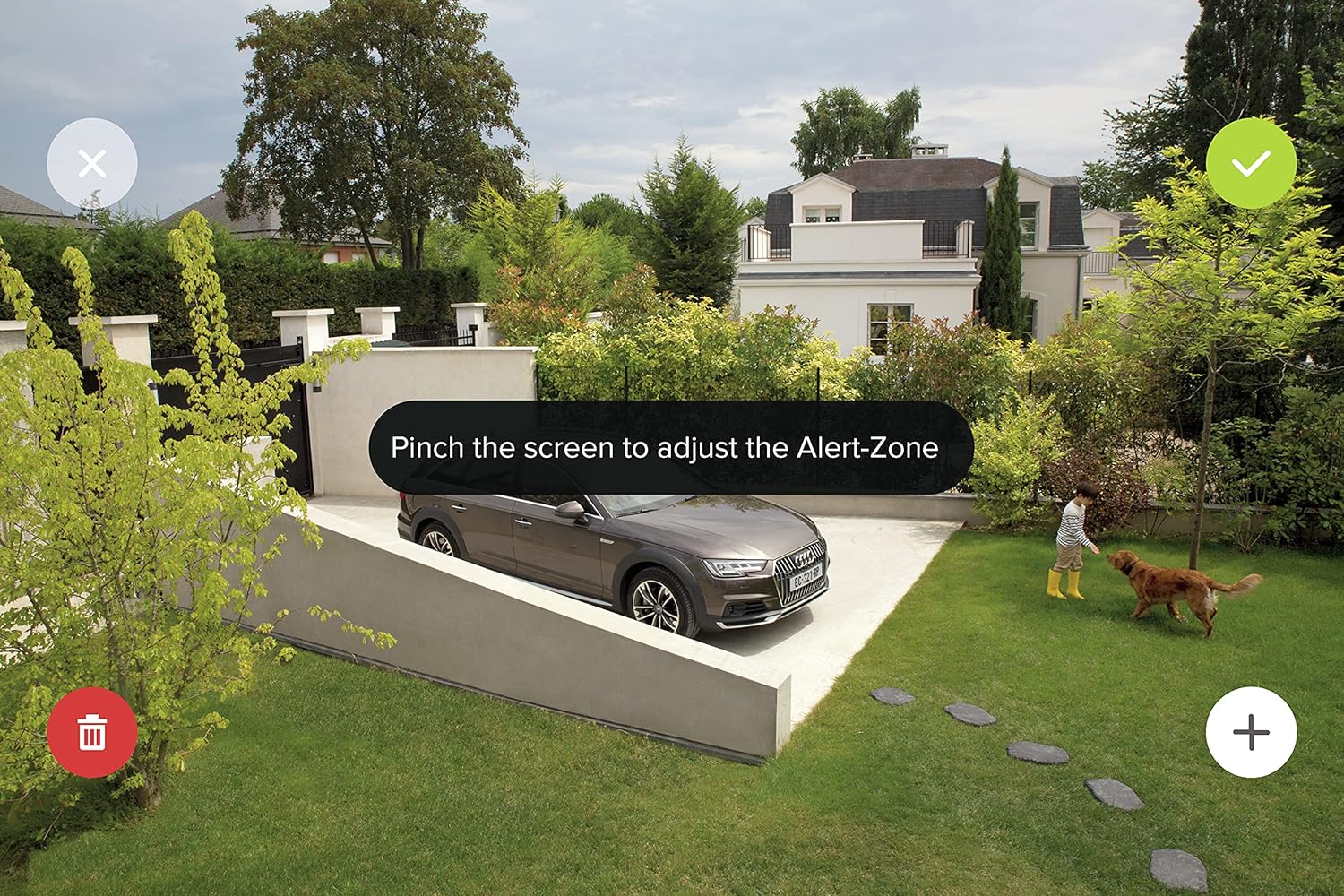 A screenshot of the Netatmo Security app showing how to define an 'Alert-Zone' on a live camera feed of a garden and driveway.