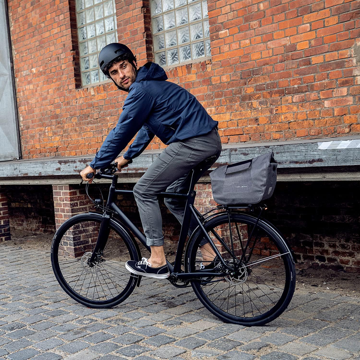 Person riding a bicycle with ORTLIEB OR-F8422 Bag