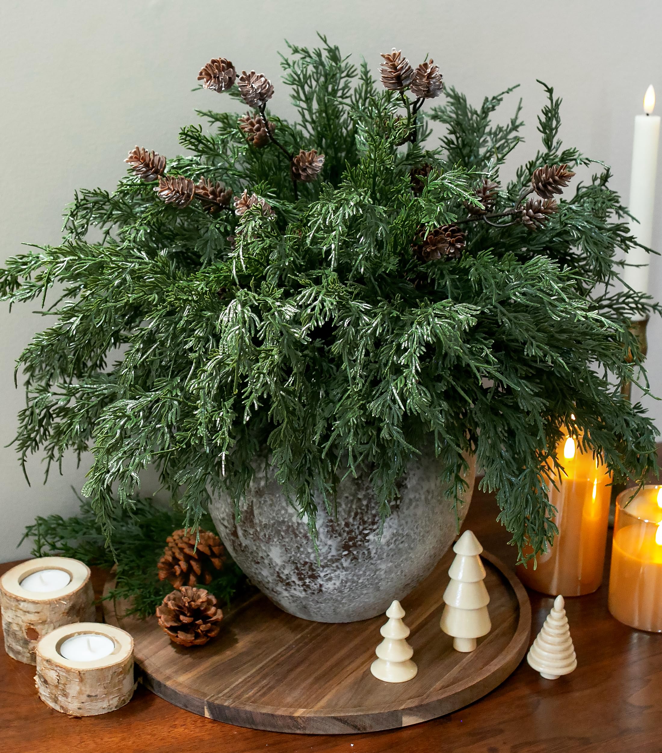 Winter living room with wood and greenery decor.