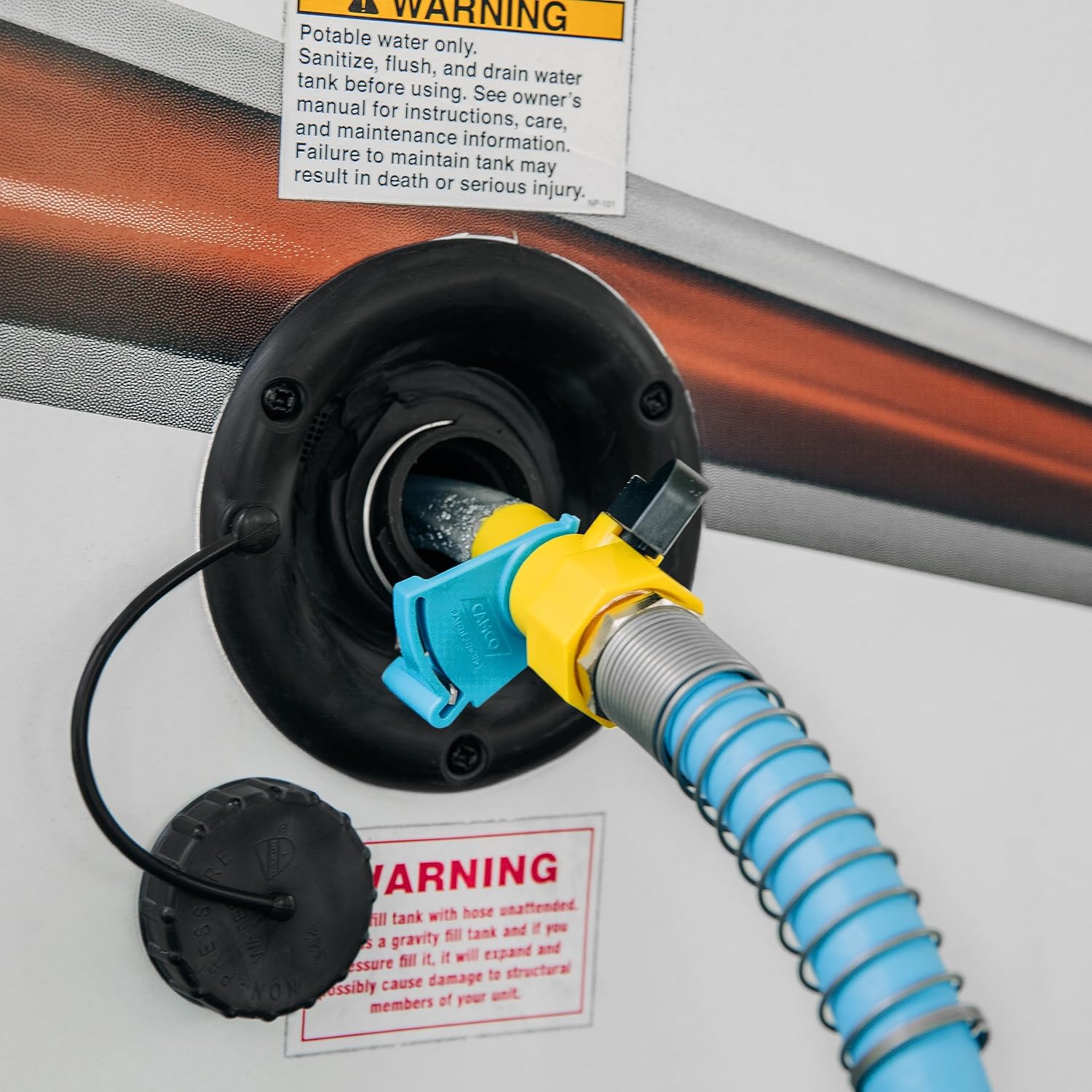 Close-up of Camco RV Water Tank Filler connected to RV