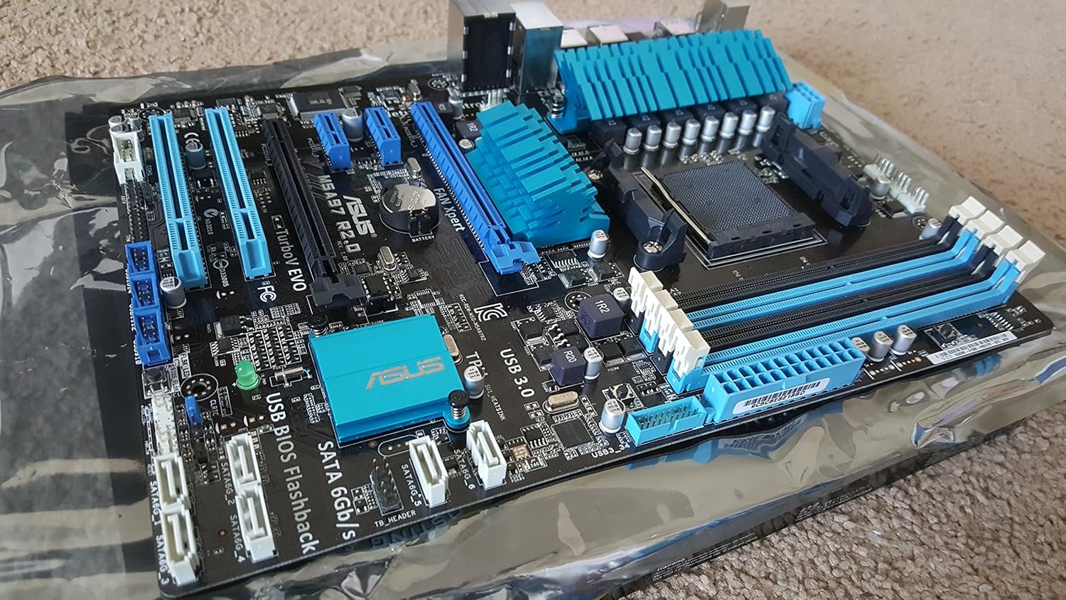 Angled view of the ASUS M5A97 R2.0 motherboard, showing SATA ports and other headers.