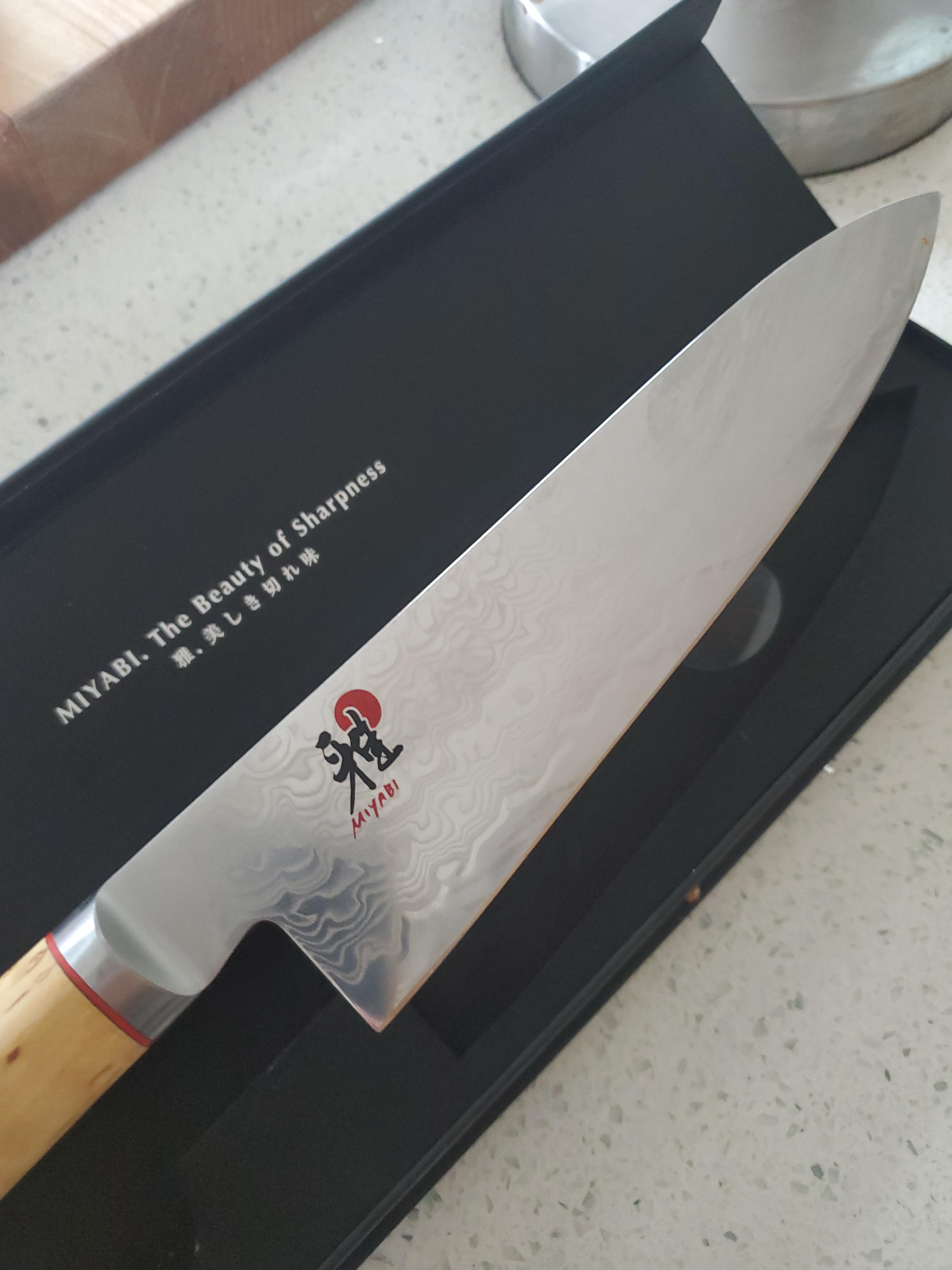 Miyabi Birchwood chef knife in use on cutting board