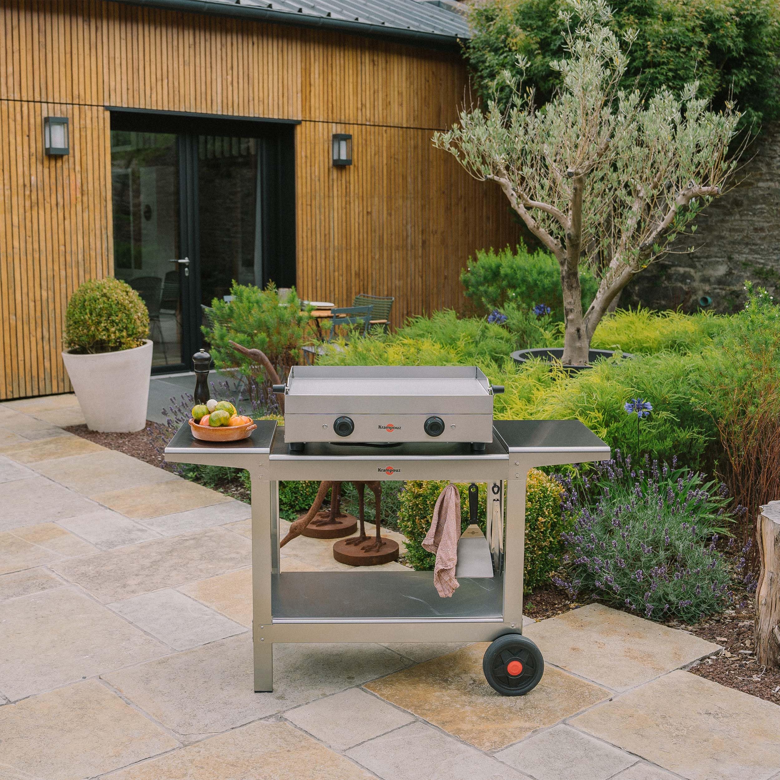 Carrito Compacto De Acero Inoxidable Para Plancha O Barbacoa Exterior KRAMPOUZ - 2 Bandejas, 2 Ruedas Grandes, Bandeja Lateral Plegable | Ref. KHEC01