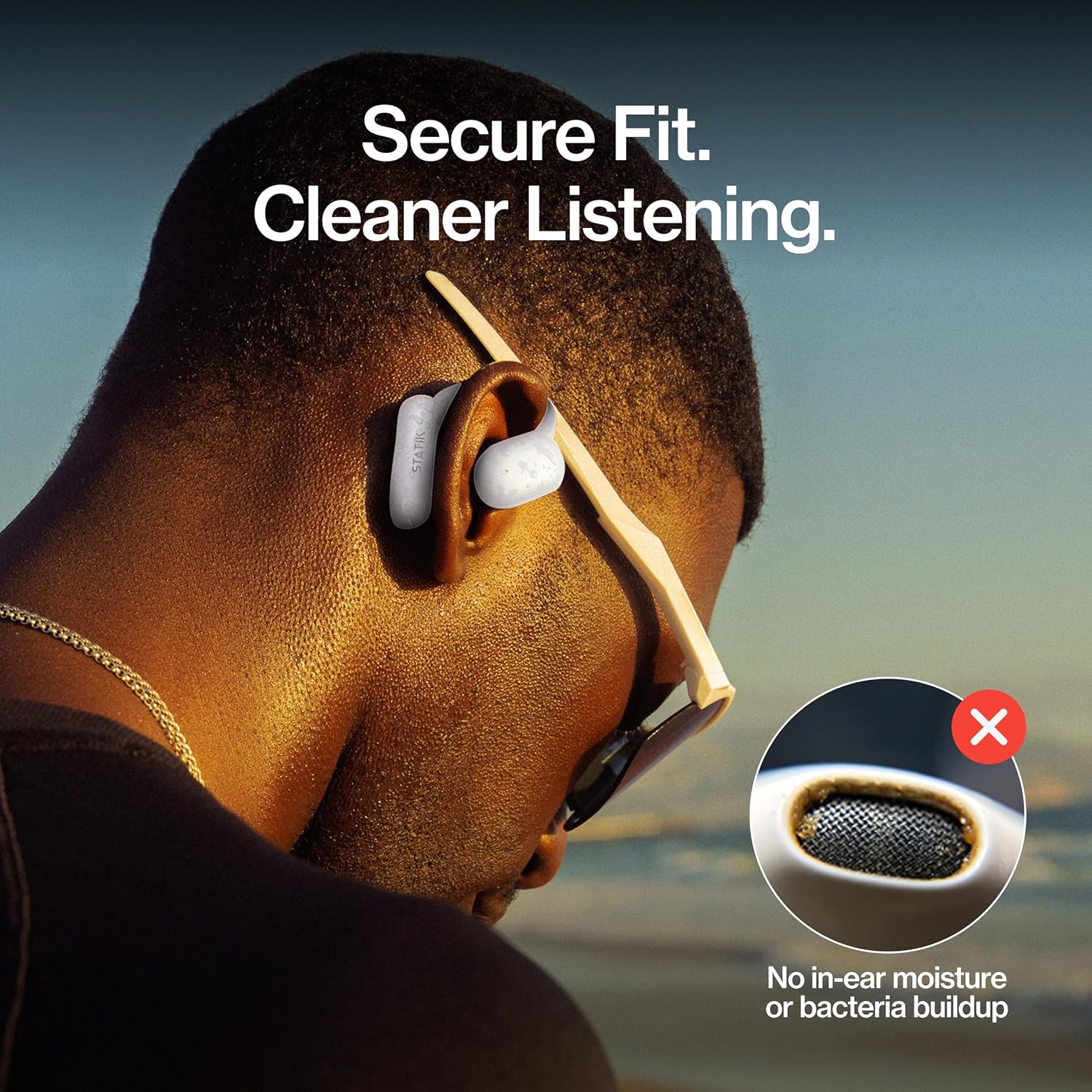 Close-up of Statik Aktive Open Ear Bluetooth Earbuds on an ear, highlighting secure fit and cleaner listening without in-ear moisture or bacteria buildup.