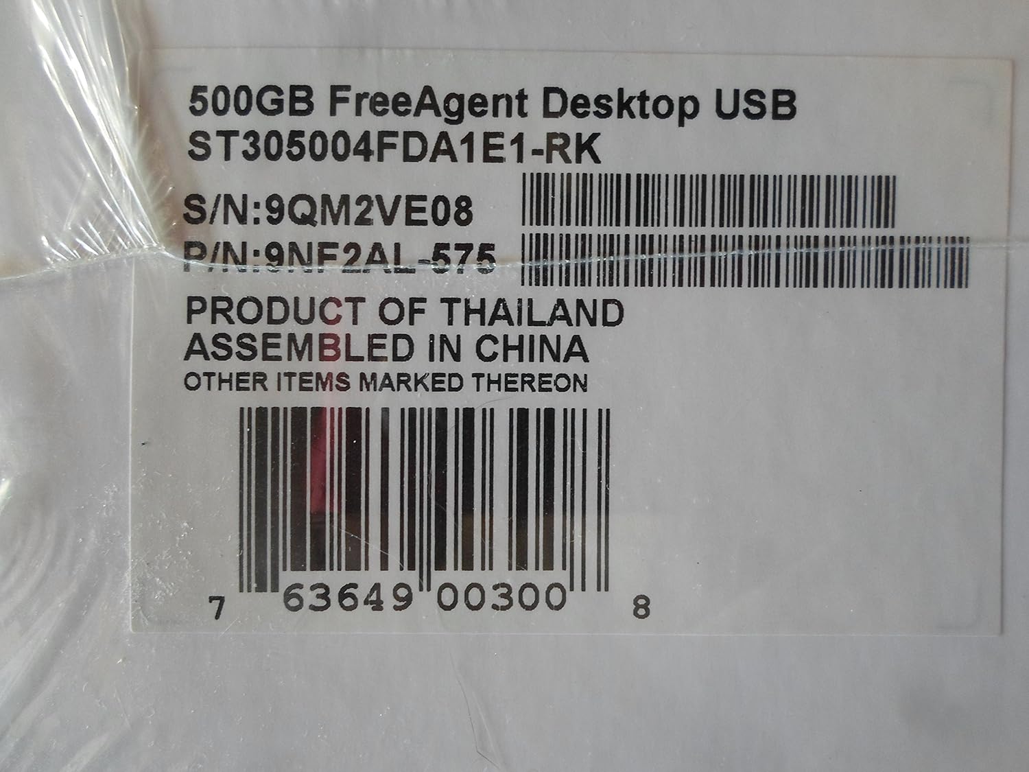 Close-up of Seagate FreeAgent product label with model, serial, and part numbers