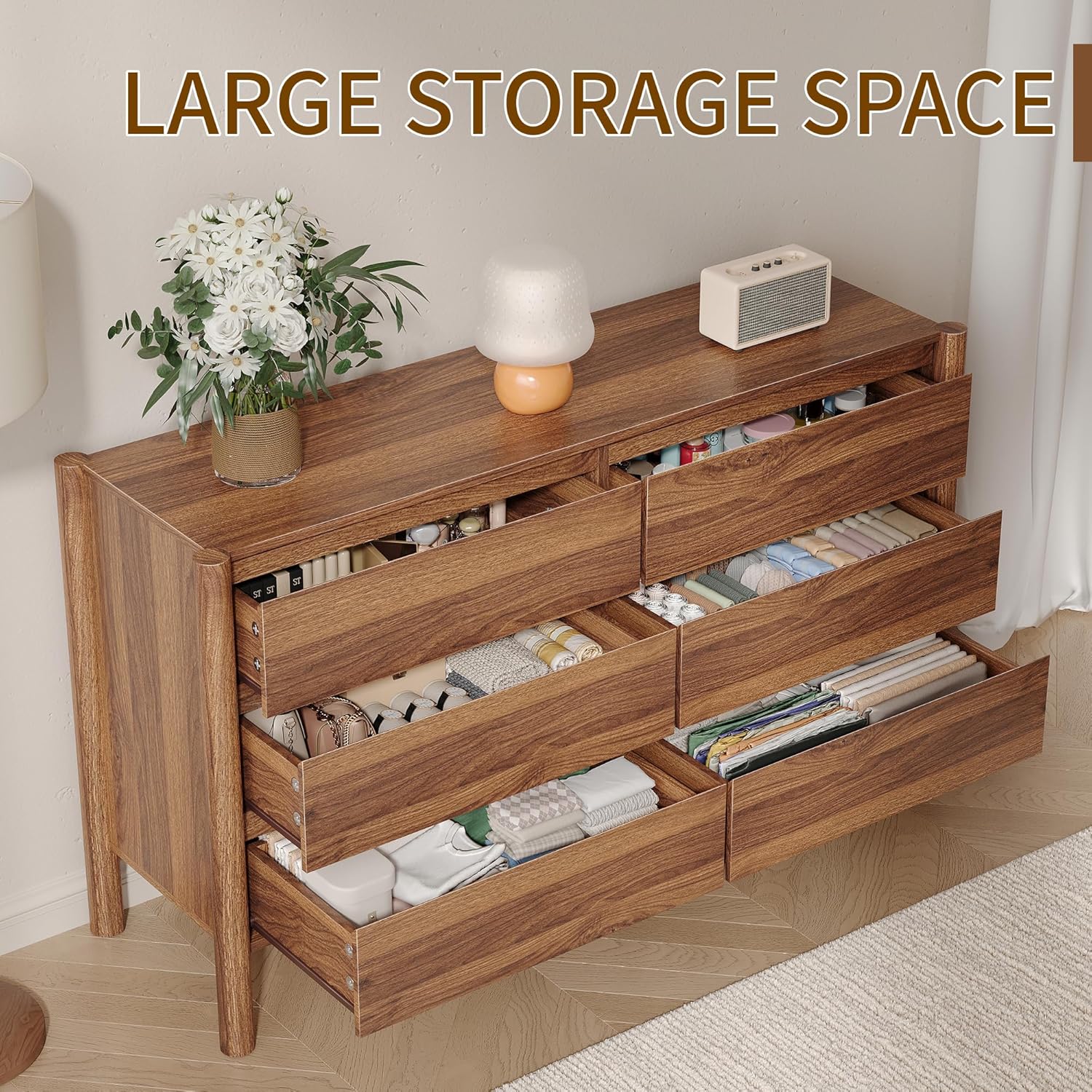 Dresser with drawers open, showing organized storage space for clothes and other items.