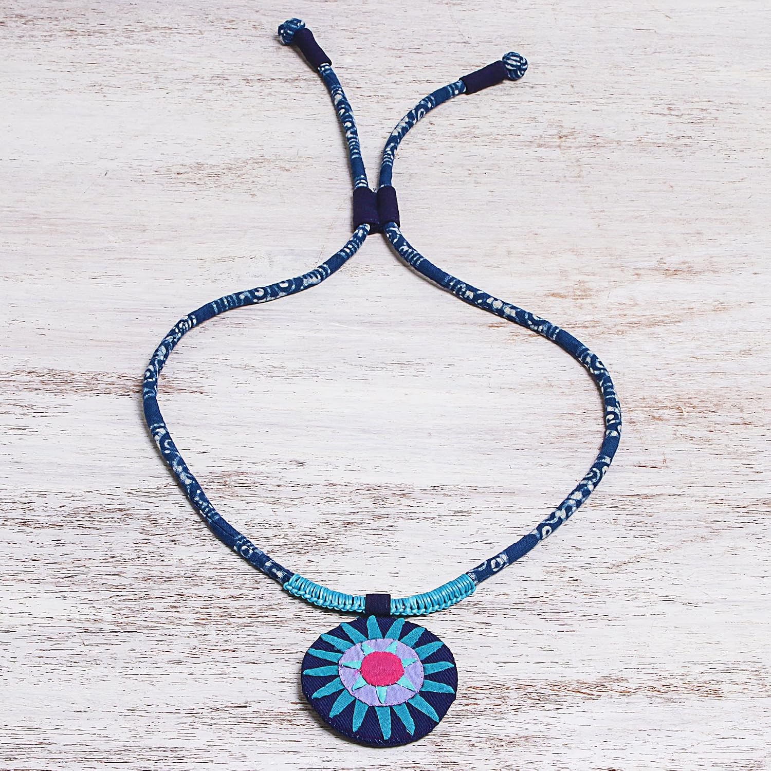 NOVICA Artisan Handcrafted Cotton Pendant Necklace in Blue from Thailand No Stone Pink Bohemian Cultural Hill Tribe Batik Sun [14.25 in min L x 30 in max L 5 mm W Pendant(s) 2.2 in Diam.] ' Blue
