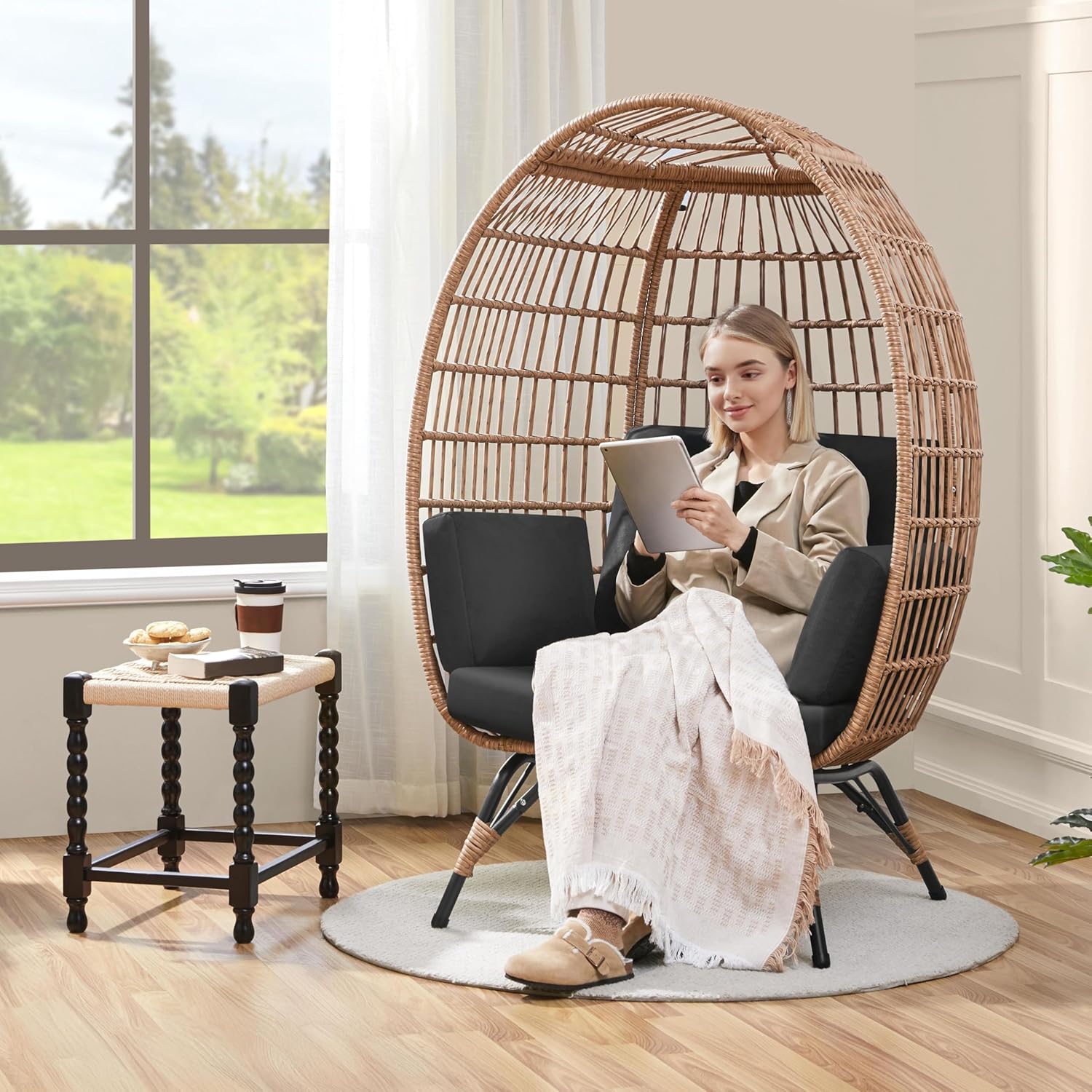 Woman relaxing in the egg chair indoors