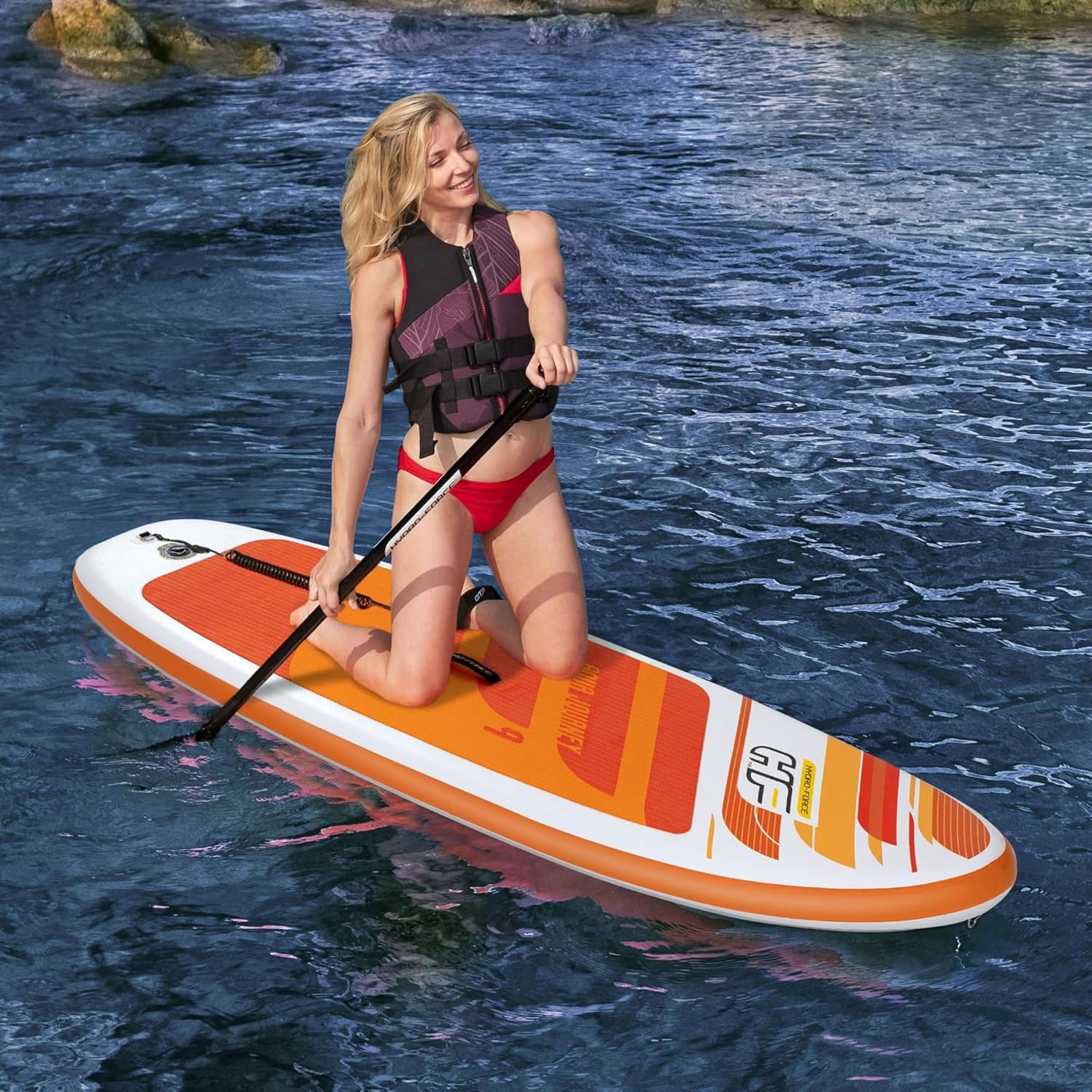 Woman kneeling on the Bestway Hydro-Force Aqua Journey 9ft SUP on calm water