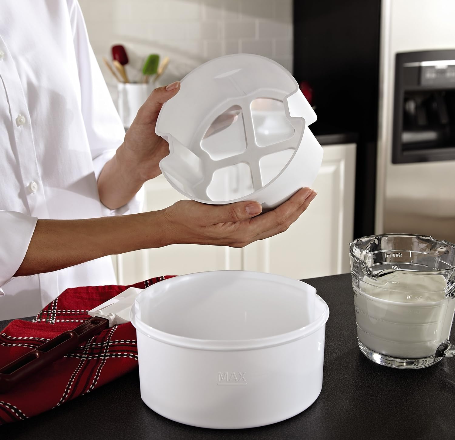 Person holding the Greek yogurt strainer component