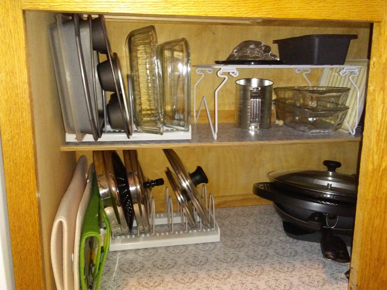 Two-tier organizer system stacked inside a deep kitchen drawer