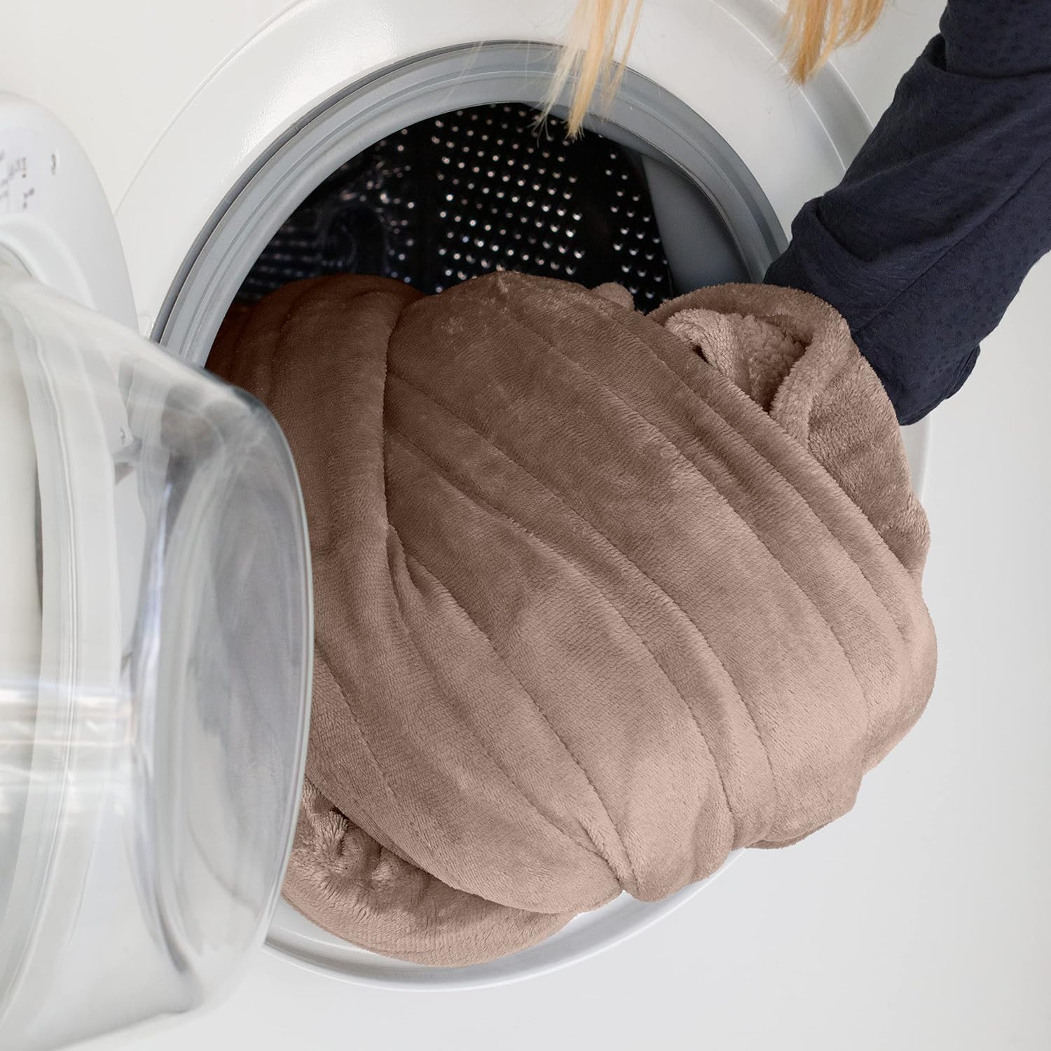 Ufesa electric heated blanket being placed into a washing machine