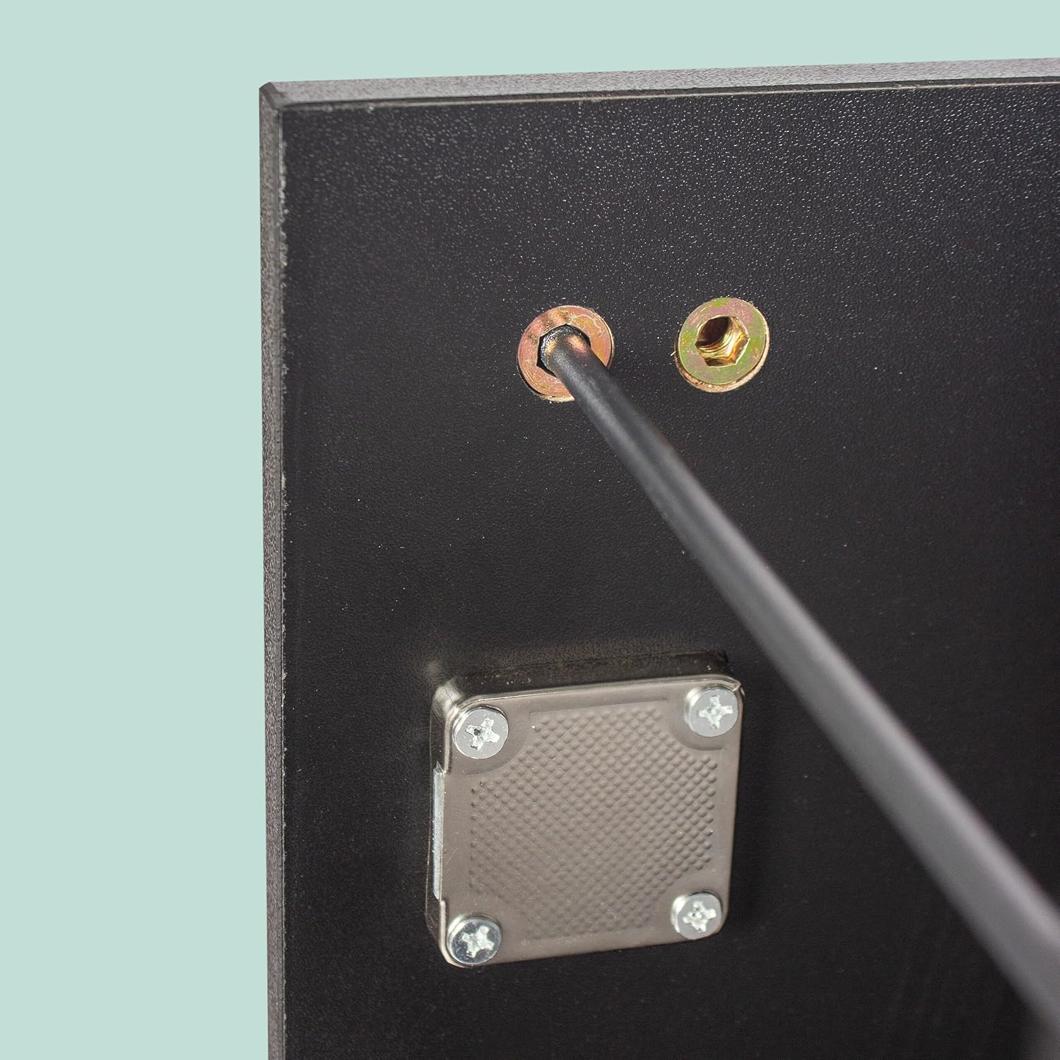 Close-up of the anti-tip mechanism being installed on the filing cabinet