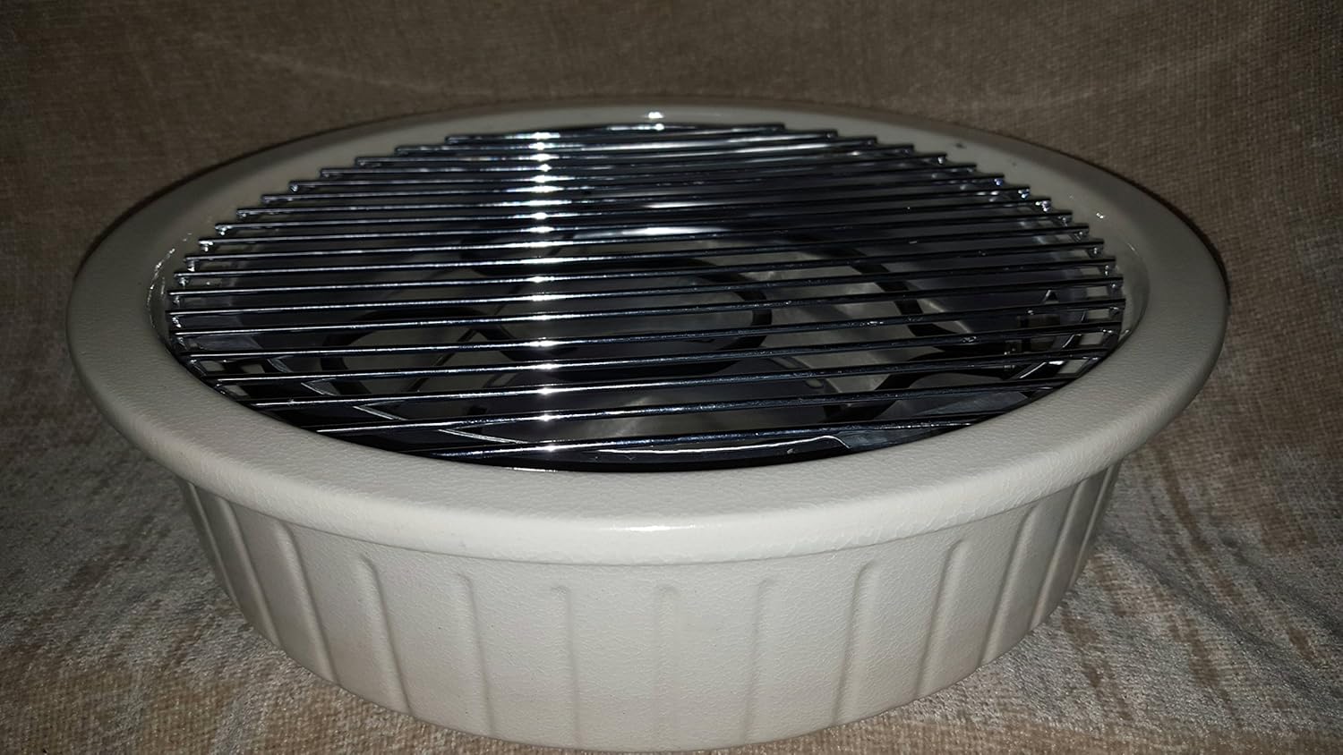 Angled view of Rival 5730M grill showing ceramic base and grate