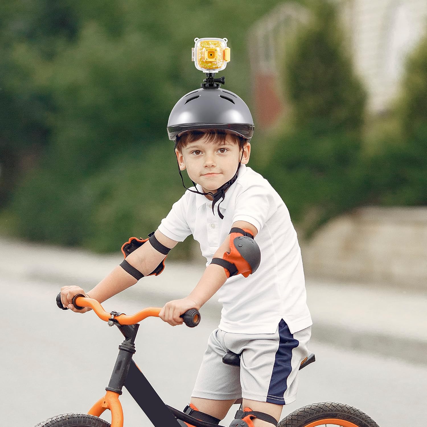 A child wearing a helmet with the Vivitar Kids Tech Action Camera mounted on top.
