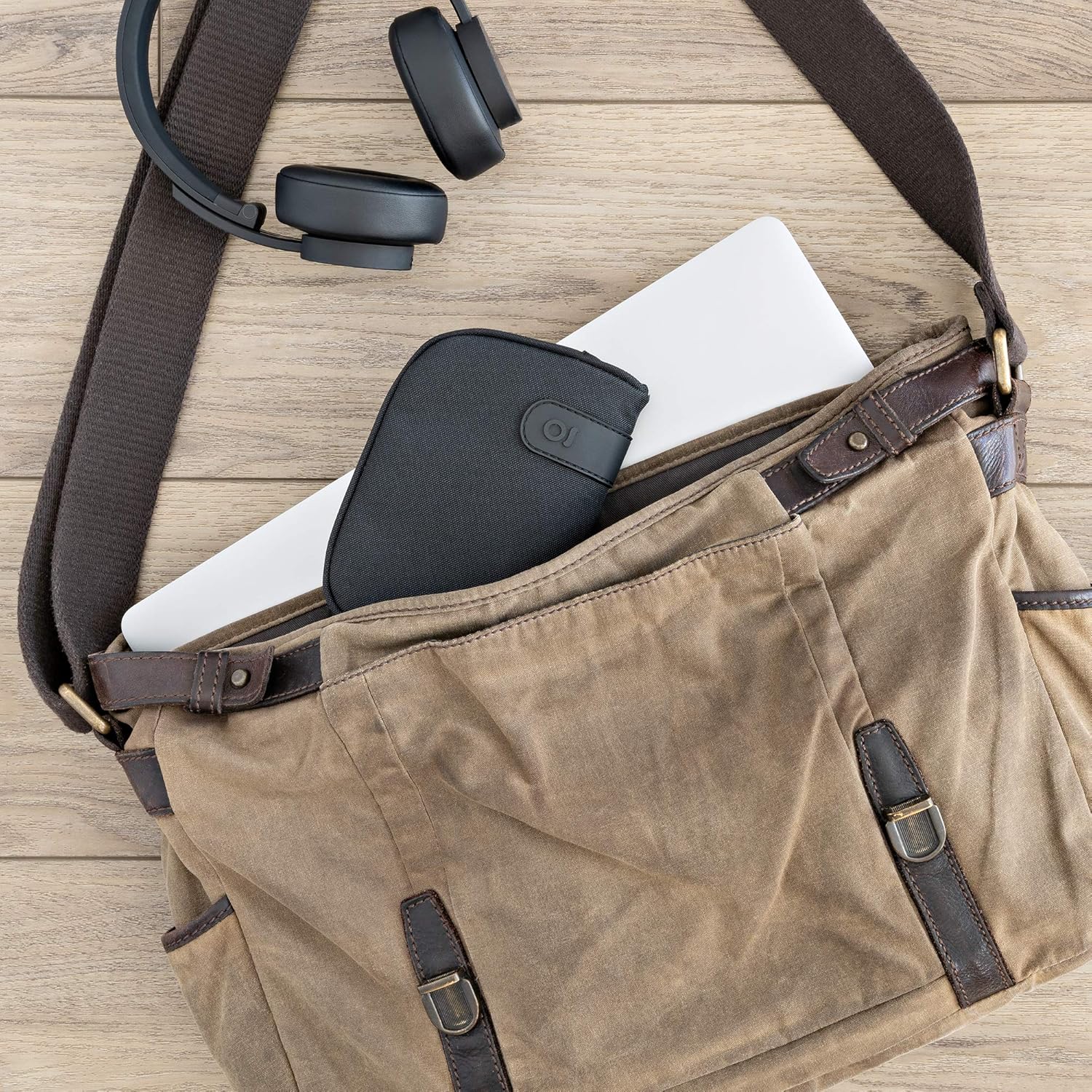 ONGROK pouch being placed into a messenger bag, showing portability