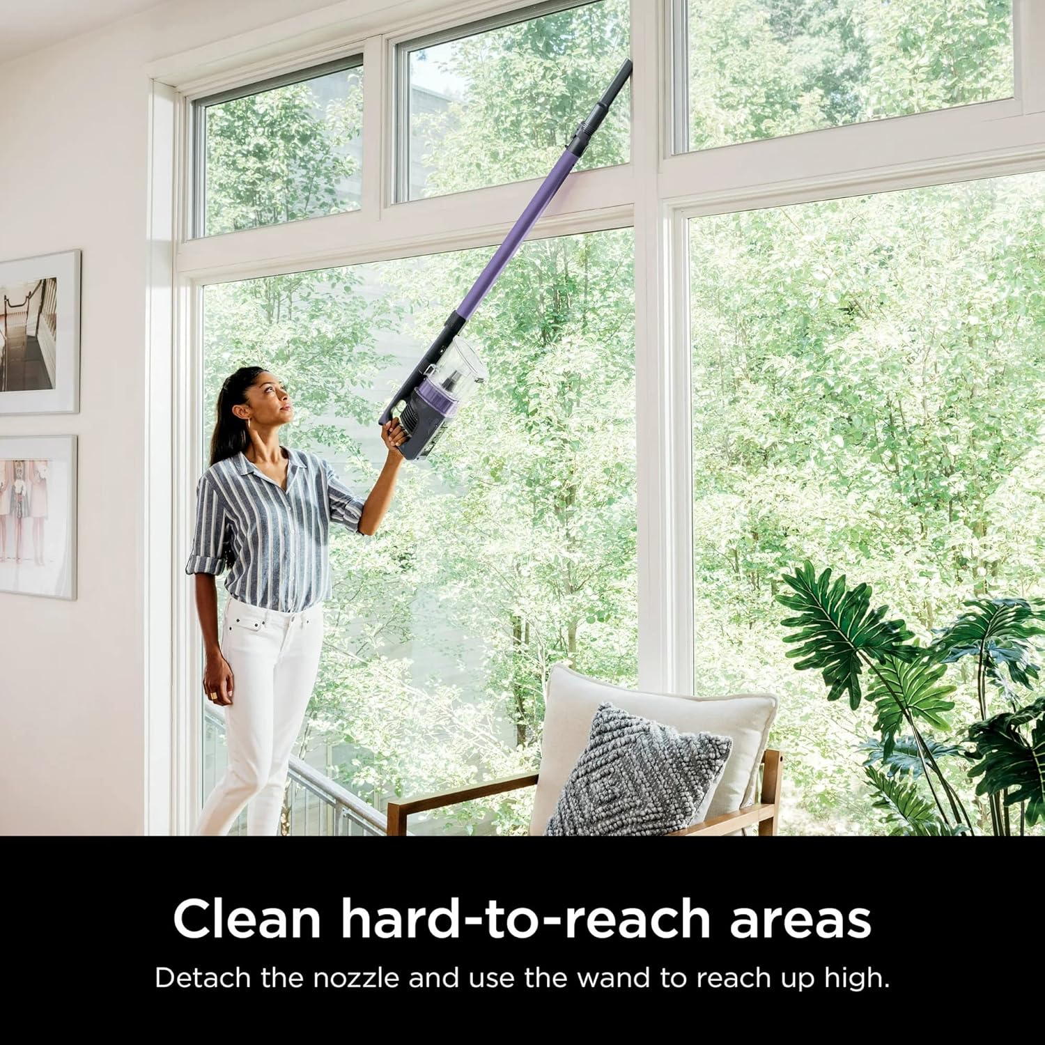 Woman cleaning high window with Shark WZ240