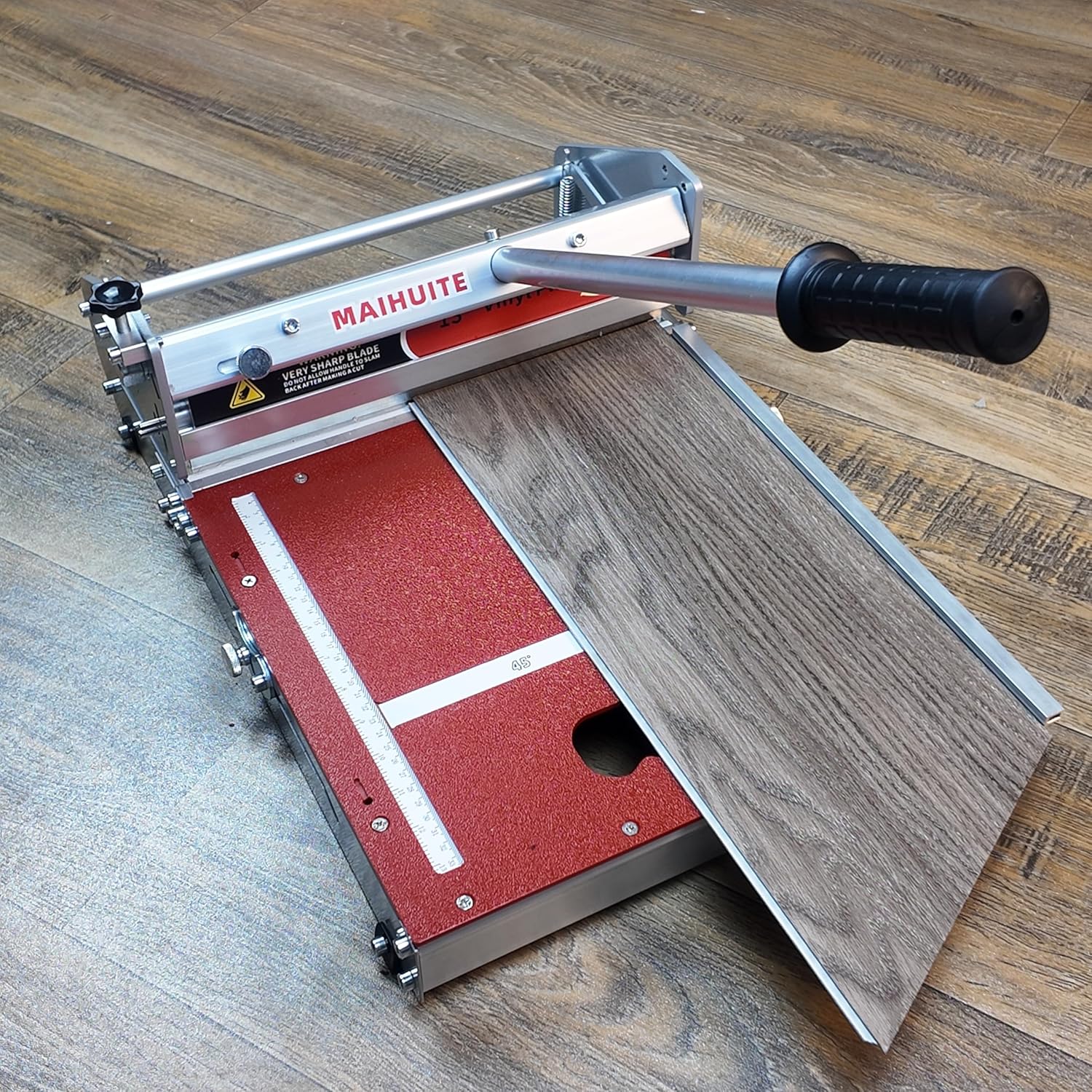 MAIHUITE 13-inch Laminate Floor Cutter demonstrating an angle cut on a vinyl plank.