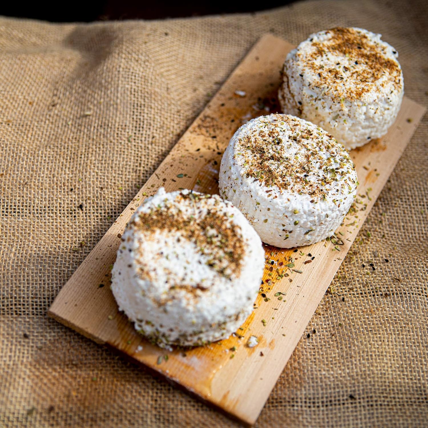 Three small round cheeses with herbs