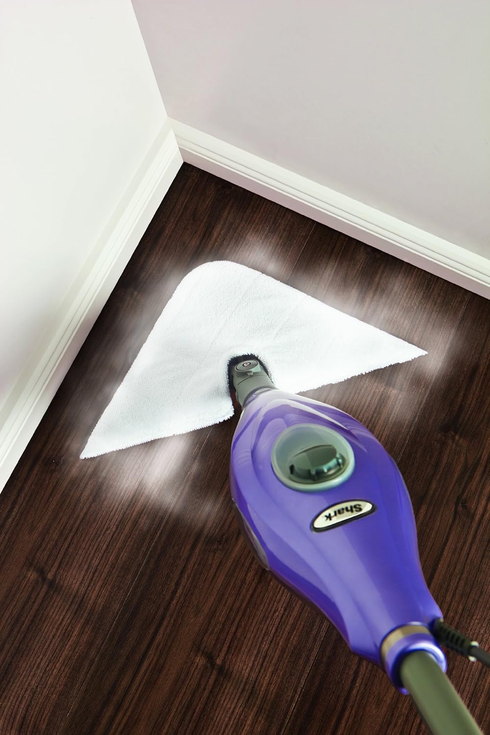 Image of the steam mop with a triangular pad cleaning a corner of a room.