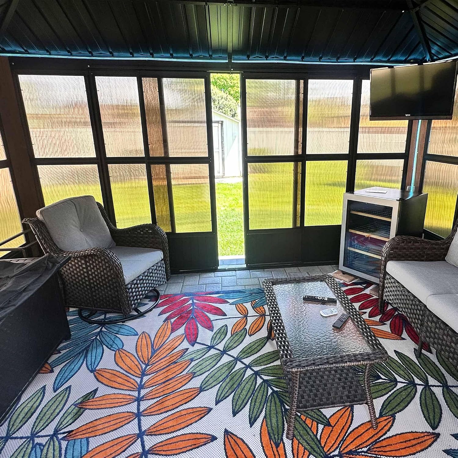 Interior view of the PURPLE LEAF Sunroom Gazebo with patio furniture