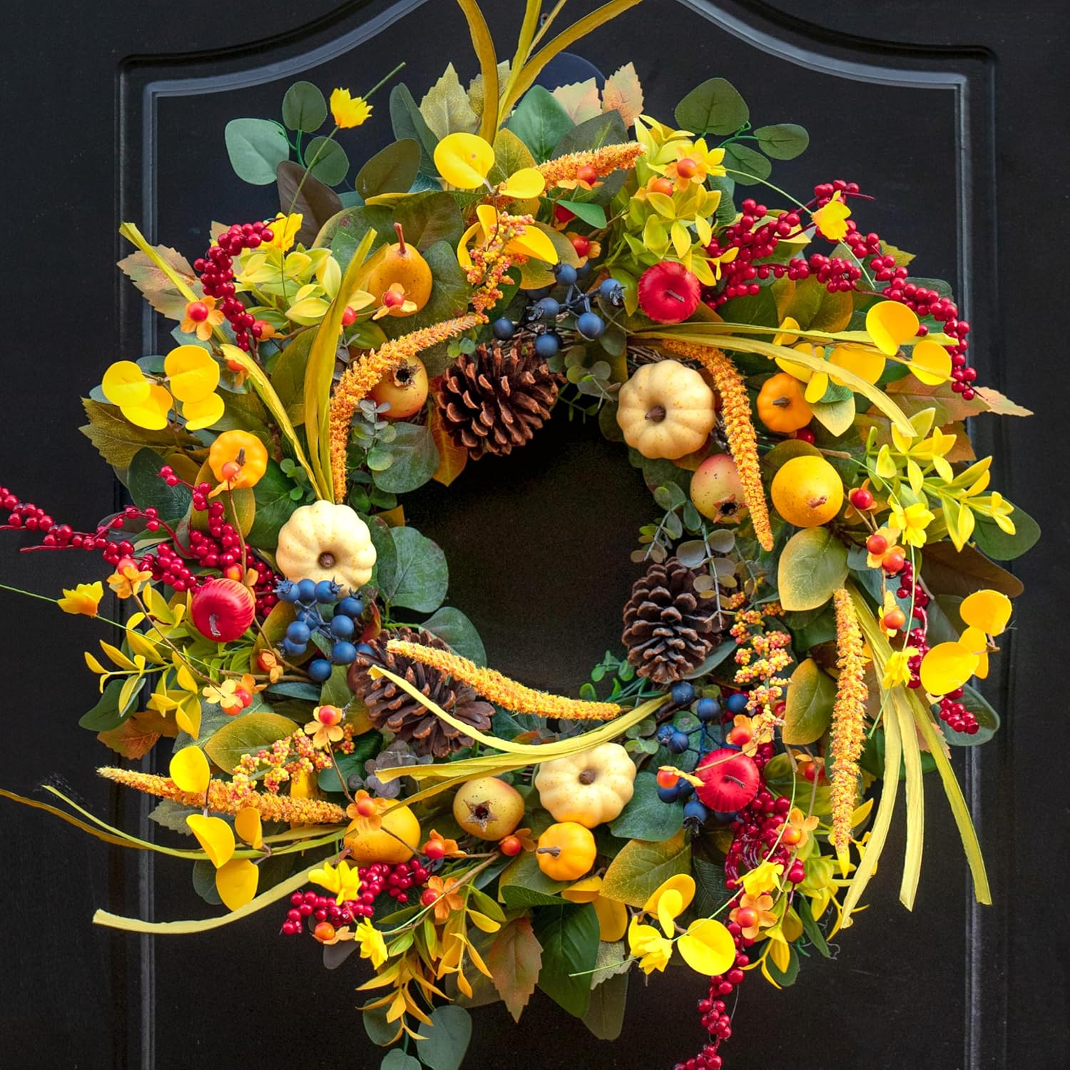 Fall Wreaths with Blue: A cheerful autumn wreath with yellow foliage, mini pumpkins, pinecones, and deep blue berries for a bright seasonal pop.
