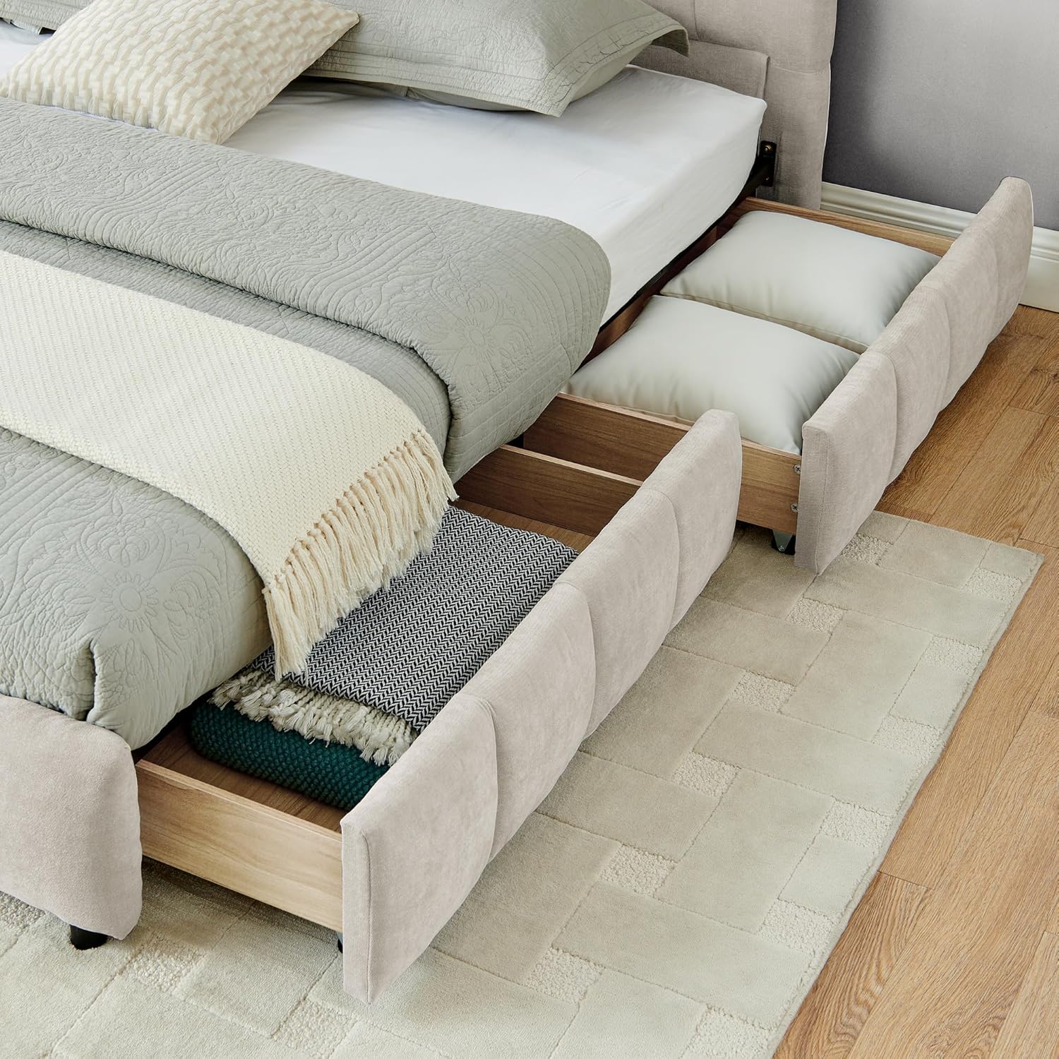 Close-up of bed storage drawers filled with pillows and blankets