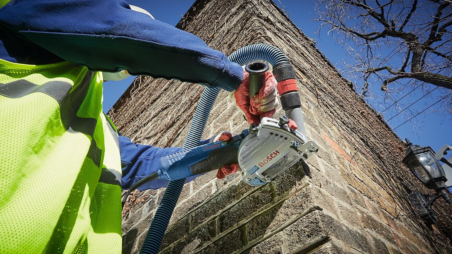 Worker using BOSCH TG503 dust guard with an angle grinder for tuckpointing