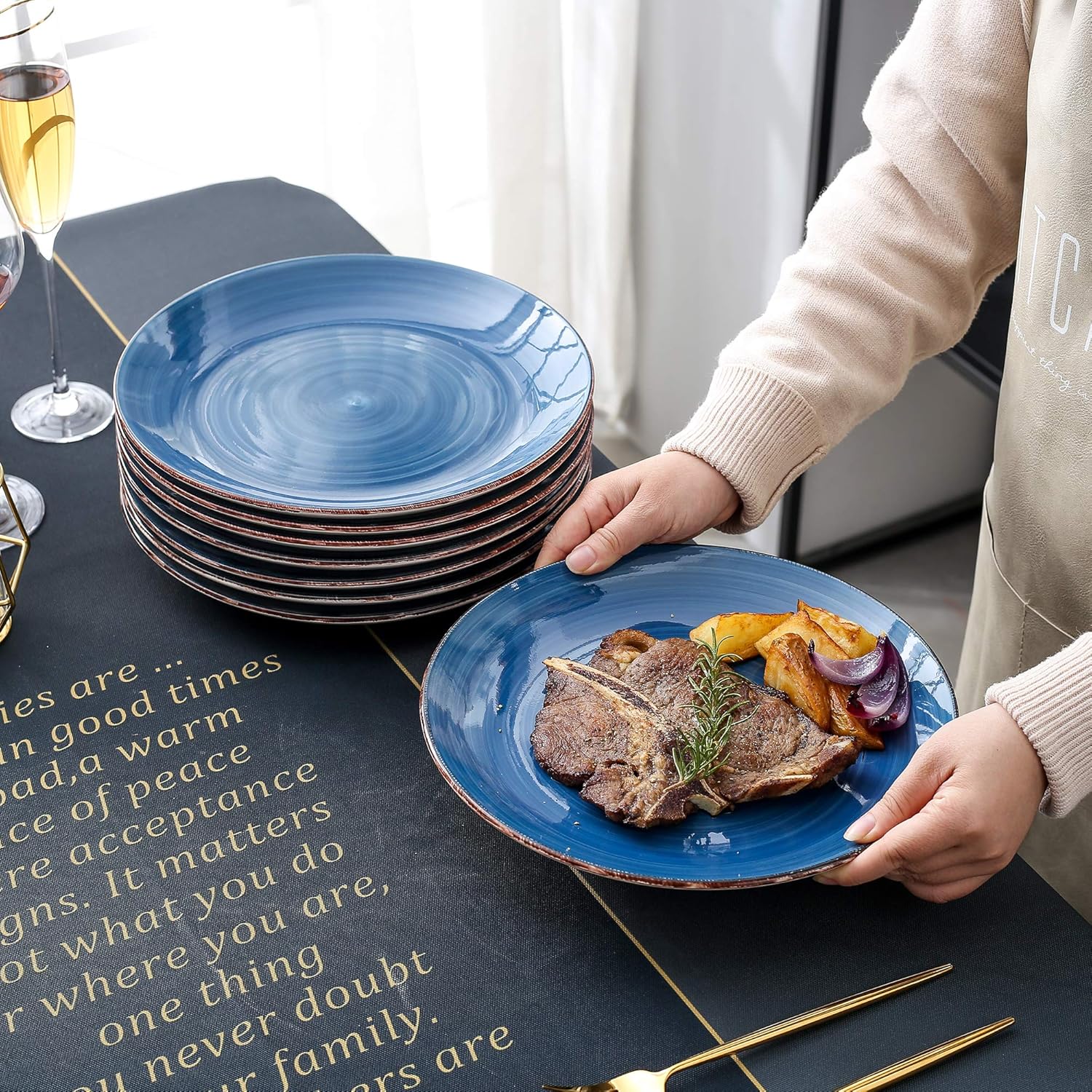 Person serving a meal onto a vancasso Bella Blue dinner plate