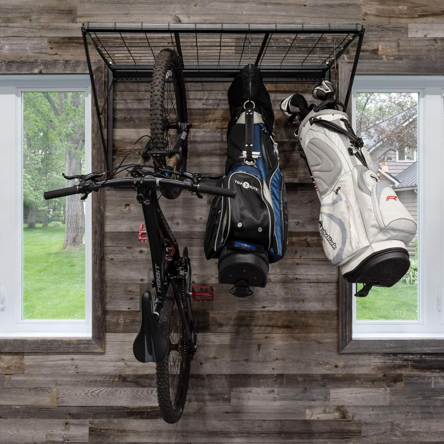 PROSLAT ProRack installed in a garage, holding a bicycle and two golf bags.